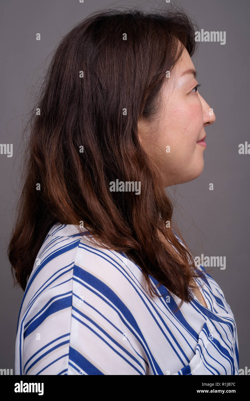 Profile view of mature beautiful Asian businesswoman face Stock Photo