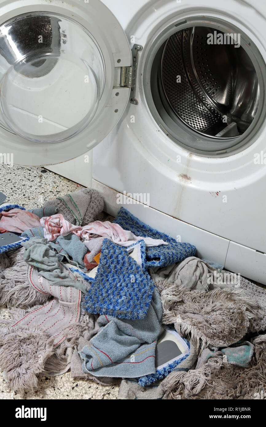broken old washing machine and many rags Stock Photo Alamy