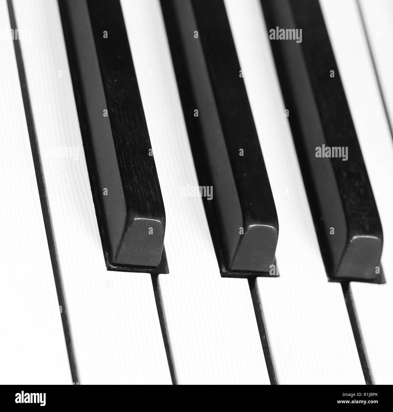 three big black piano keys and white ivory keys Stock Photo Alamy