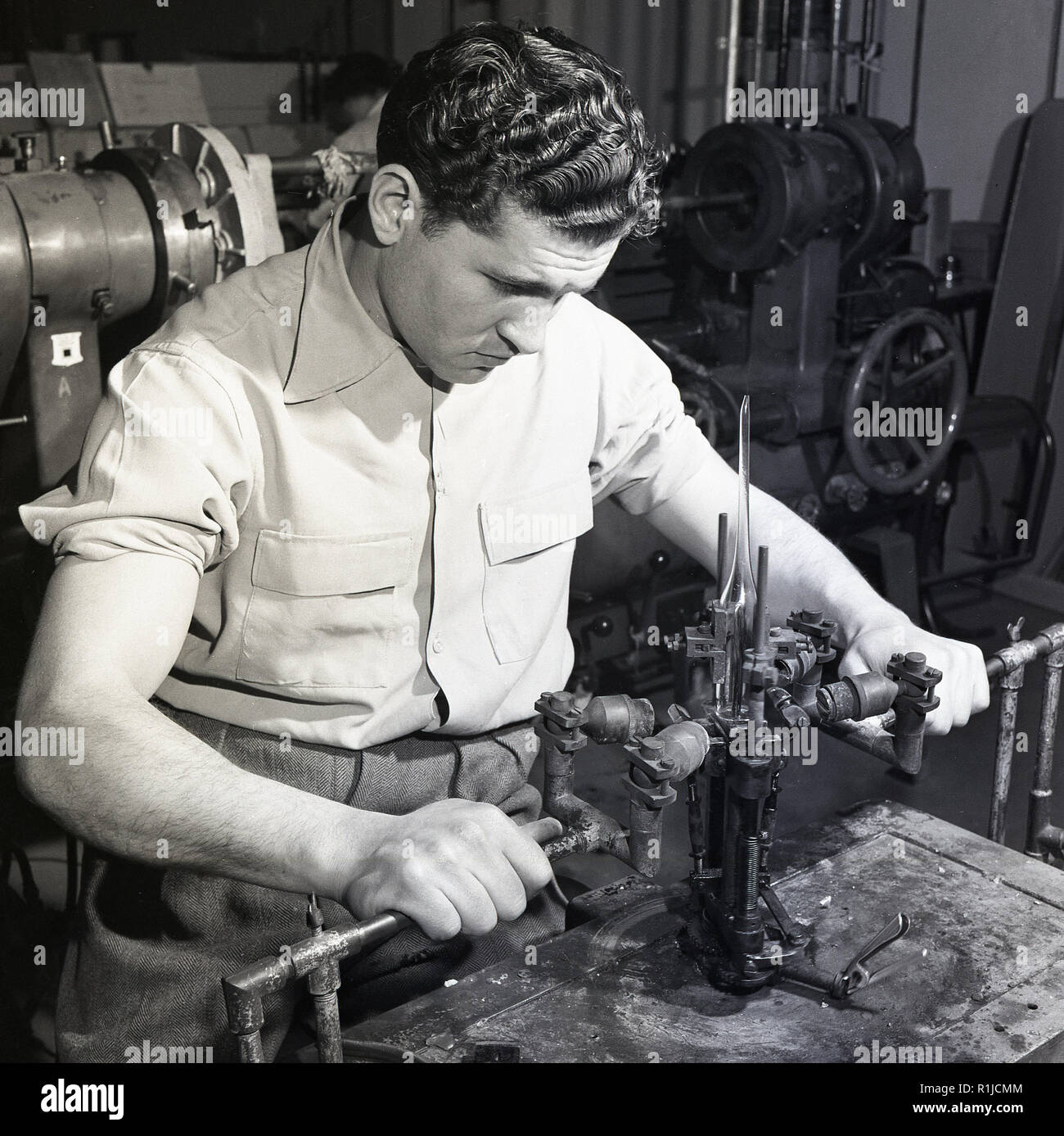 1950s, historical, a skilled male worker using gas burners to join