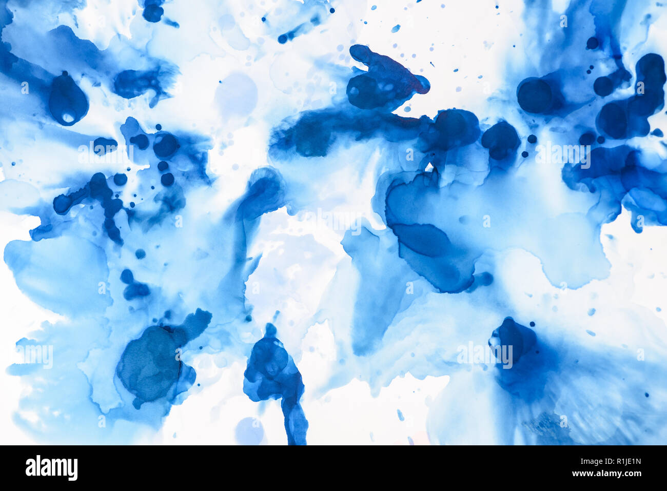 Alcohol Ink Splashes textured blue splashes of alcohol ink on white as abstract background ...