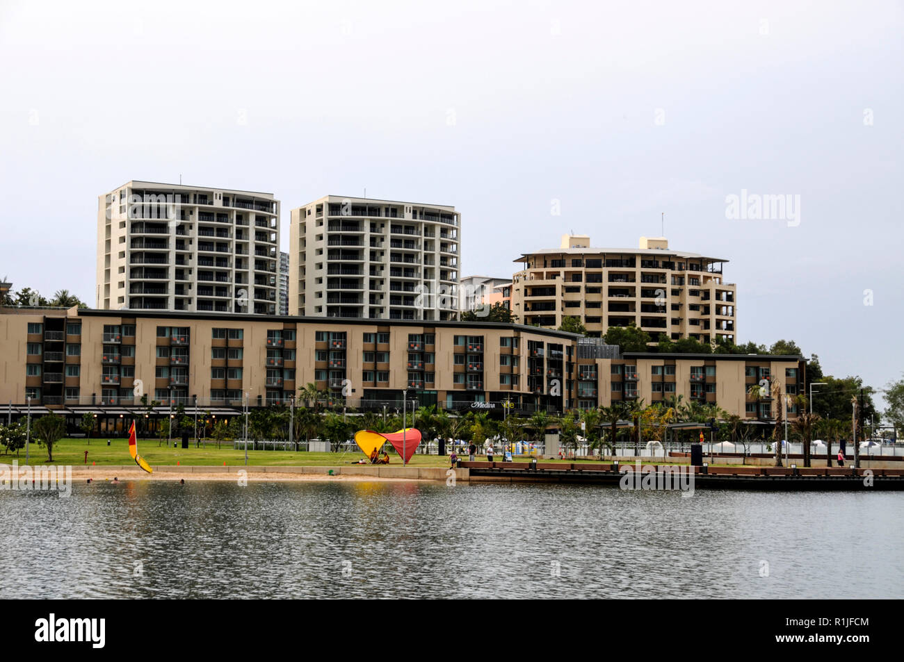 Apartments and a mix of eateries and a large swimming pool along the waterfront precinct, near to the historic Stokes Hill Wharf at Darwin in the Nort Stock Photo