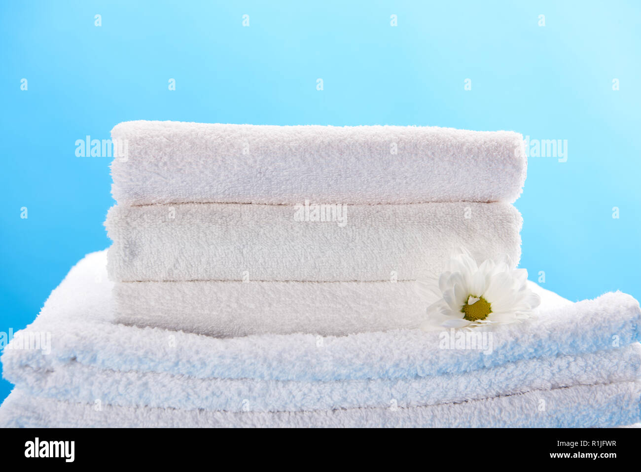 Stack of clean fluffy white towels on the bed Stock Photo - Alamy