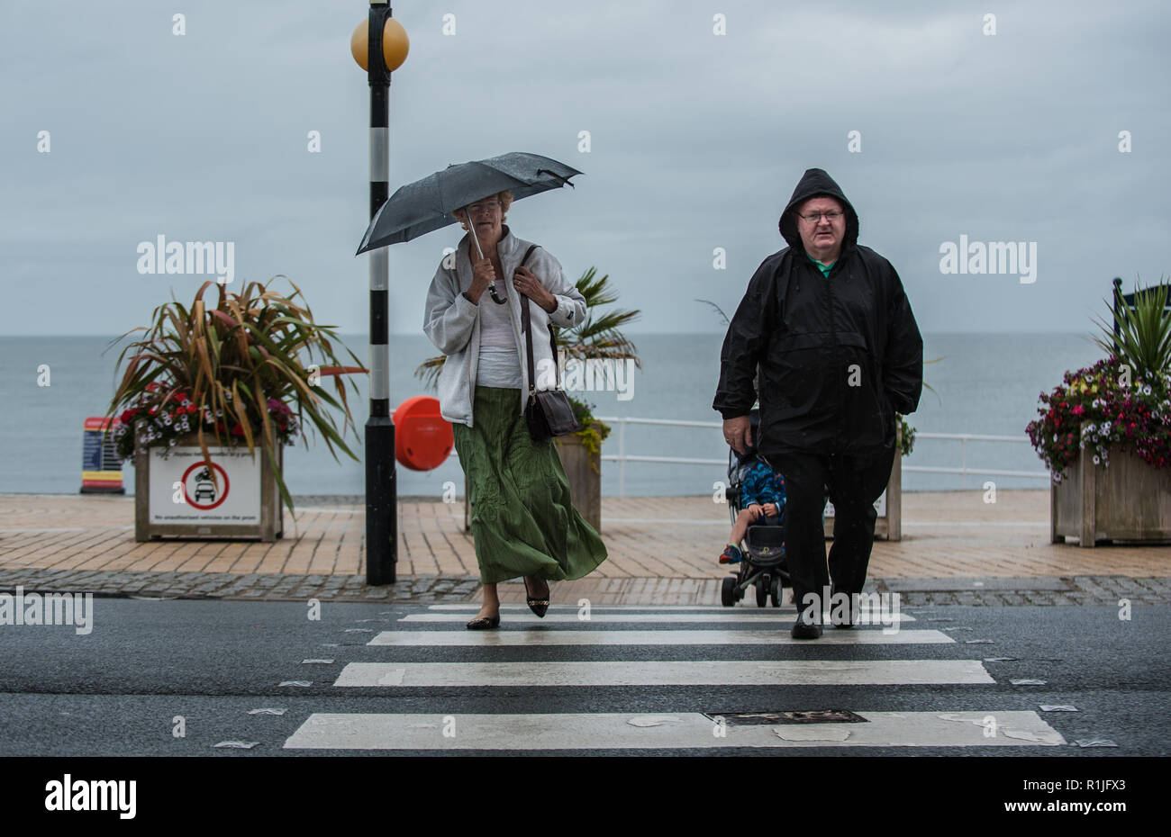 People going about their daily life in the rain. Stock Photo