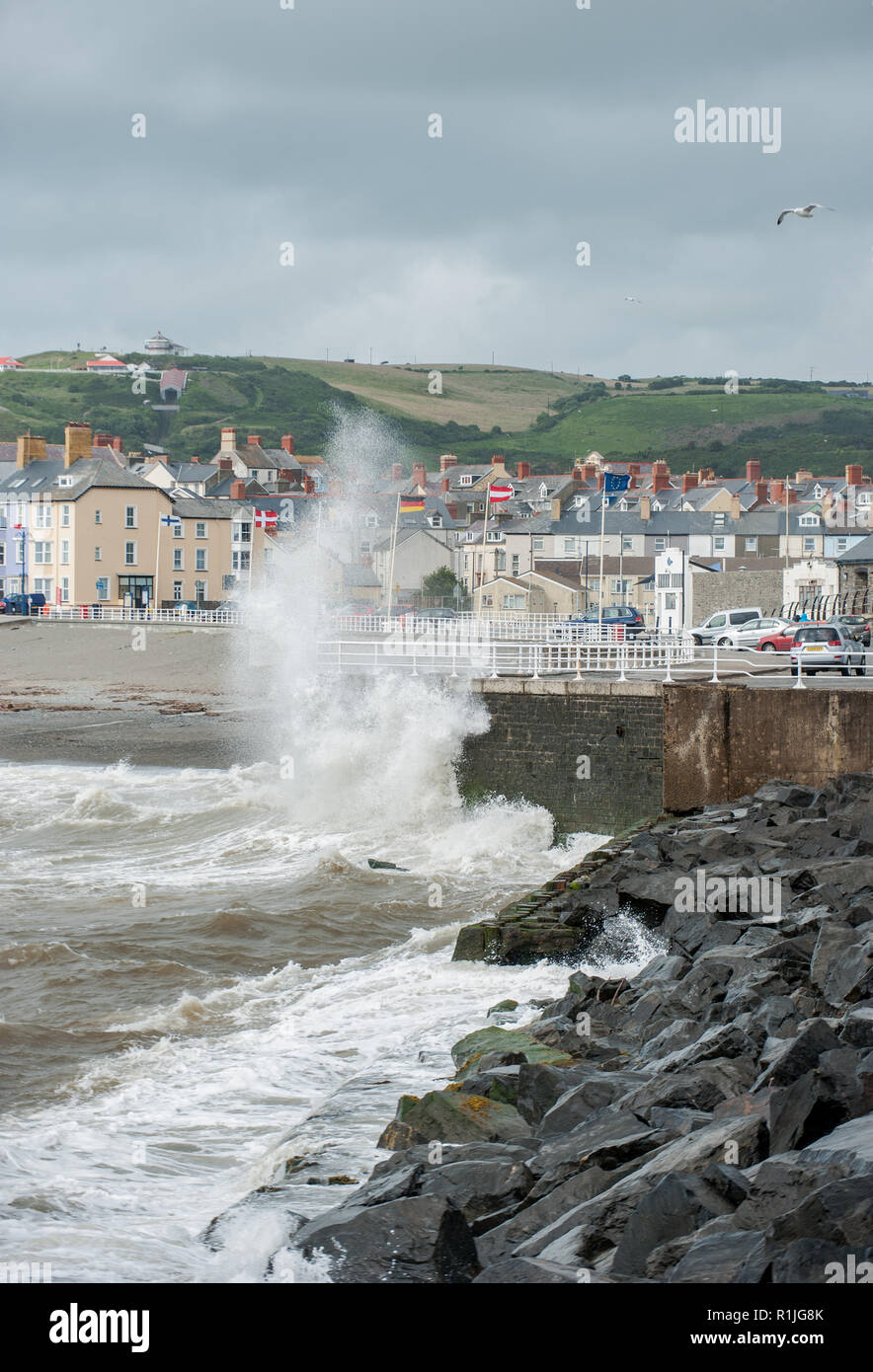 Waves start to batter the harbour as it reachs high tide and the winds increase. Stock Photo