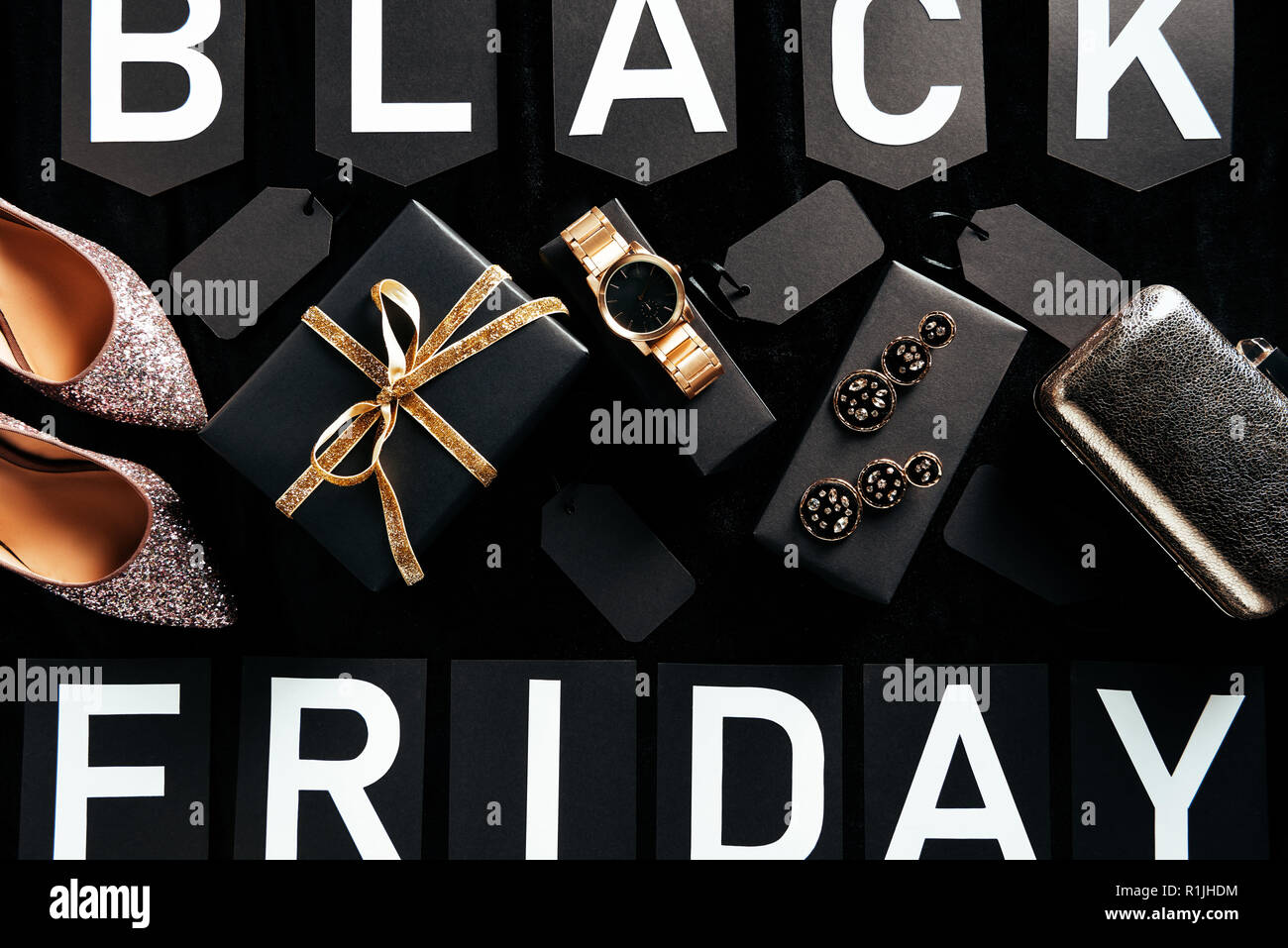 flat lay with feminine shoes, jewelry and purse with blank price tags on  black background, black friday concept Stock Photo - Alamy