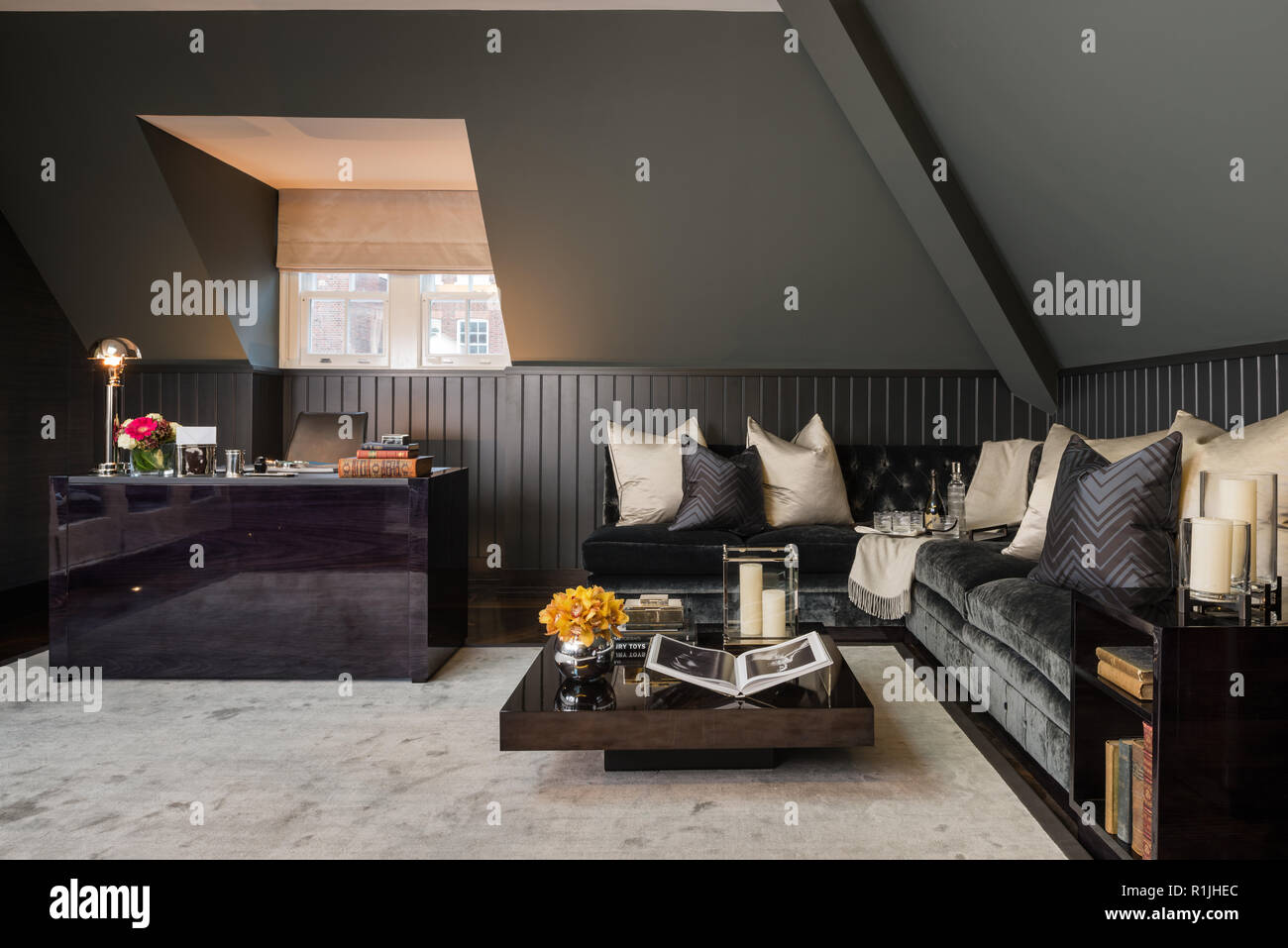 Black living room with desk Stock Photo - Alamy