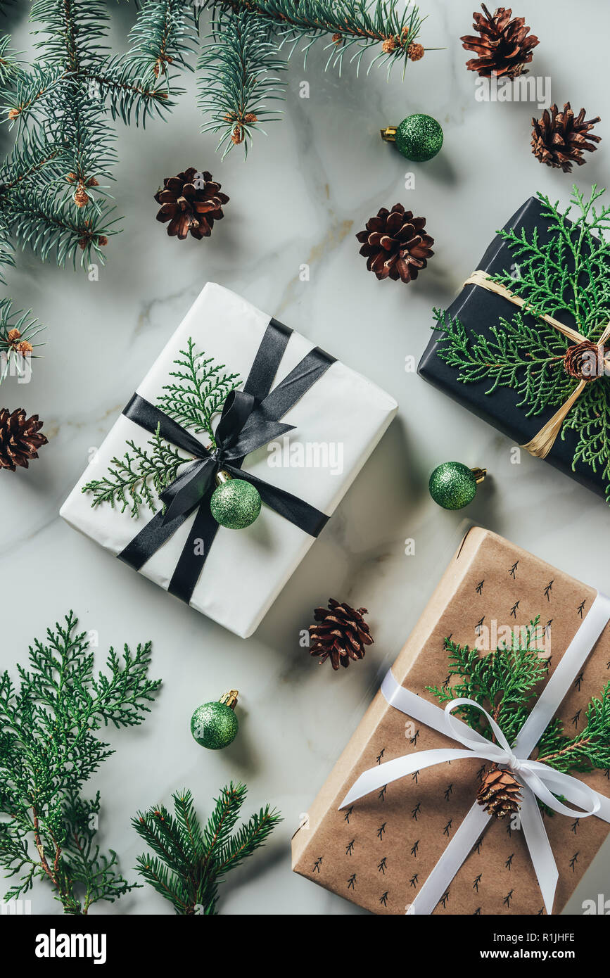 Flat Lay With Presents Christmas Balls And Pine Cones On Marble