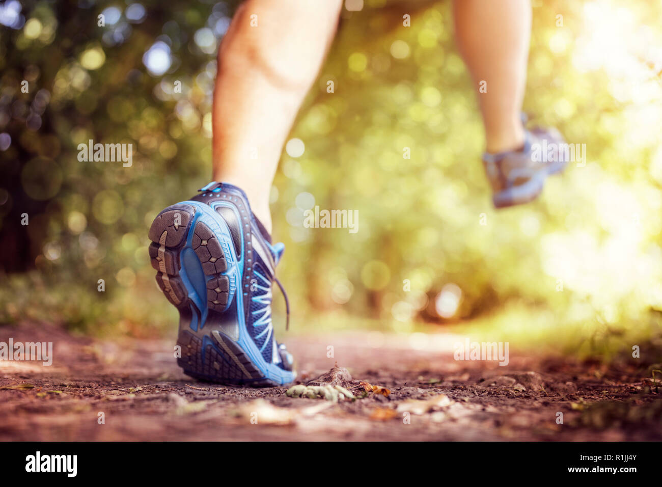 Outdoor cross-country running in summer sunshine concept for exercising, fitness and healthy lifestyle Stock Photo