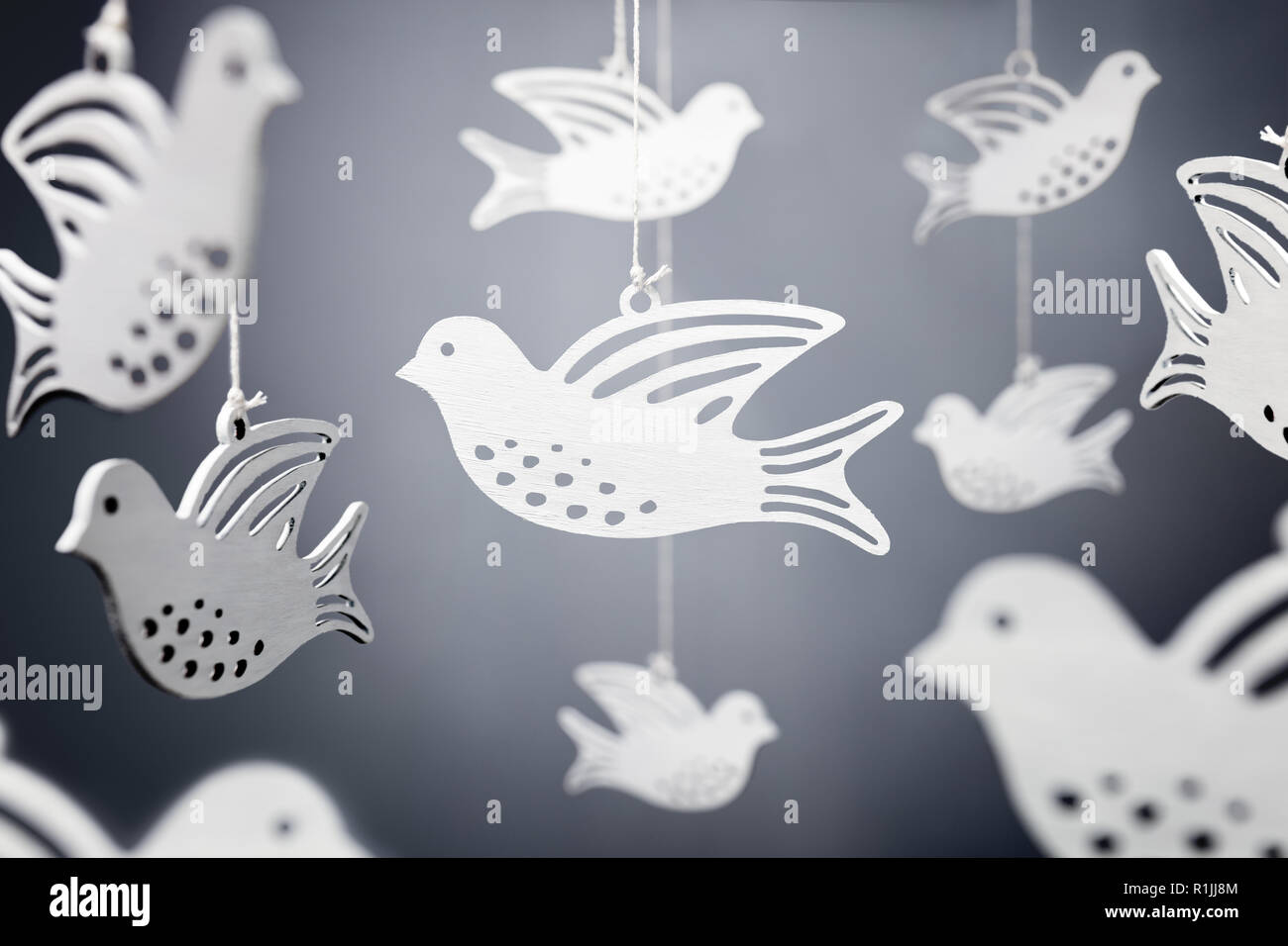 White dove shapes hanging on string symbol of peace Stock Photo