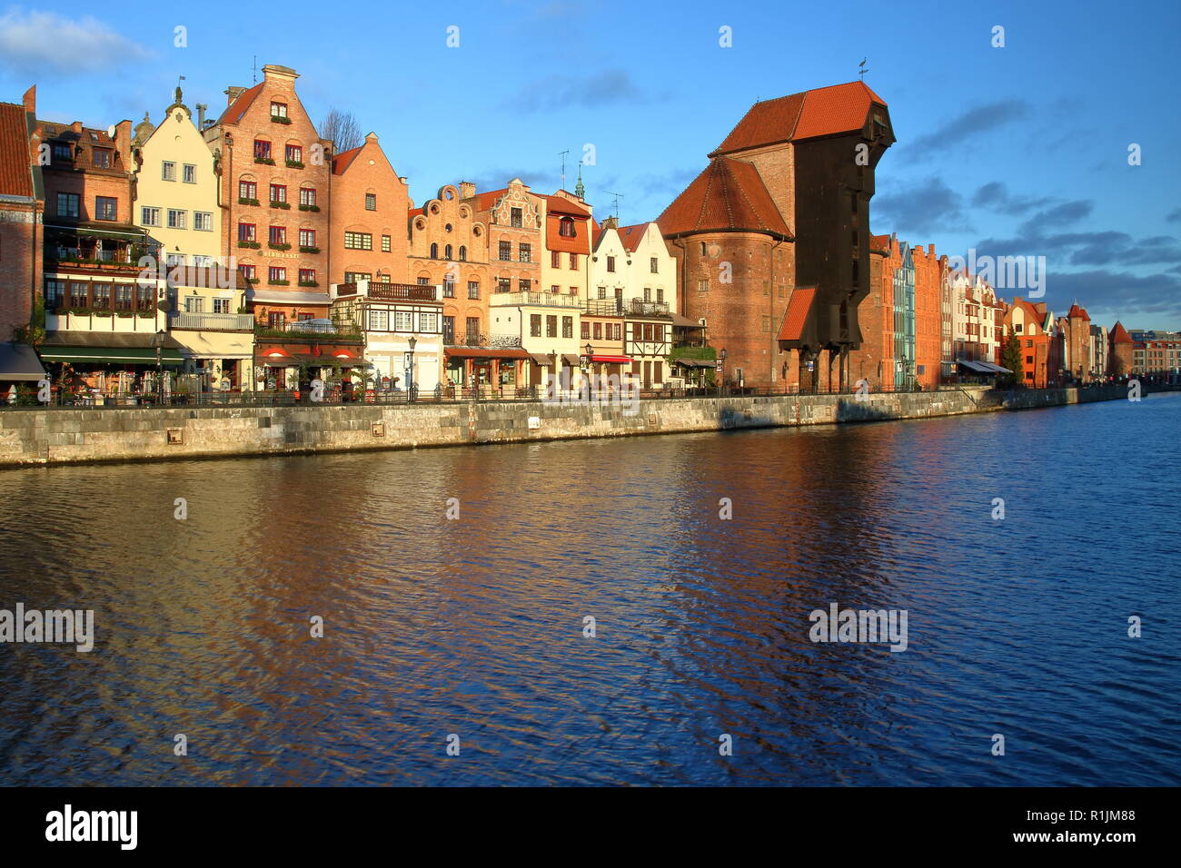 Panoramic cityscape of Gdańsk, Poland, river, shore, beautiful hitorical architecture, medieval crane - museum today. Stock Photo