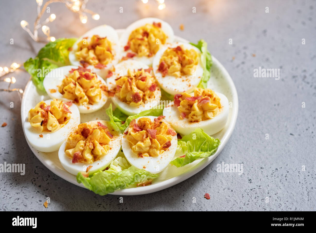 Healthy Deviled Eggs as an Appetizer with Bacon Stock Photo