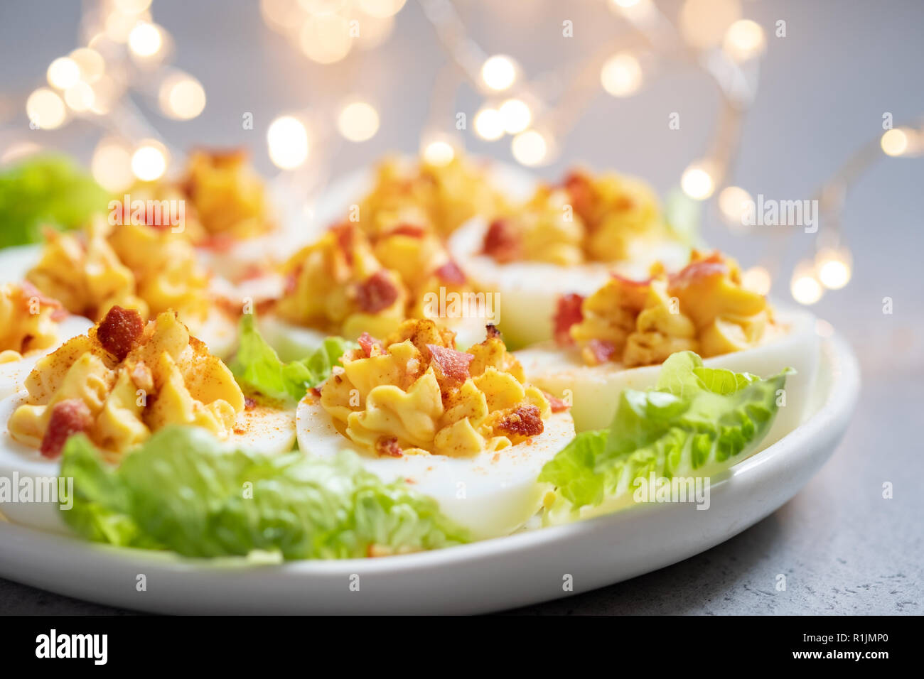 Healthy Deviled Eggs as an Appetizer with Bacon Stock Photo
