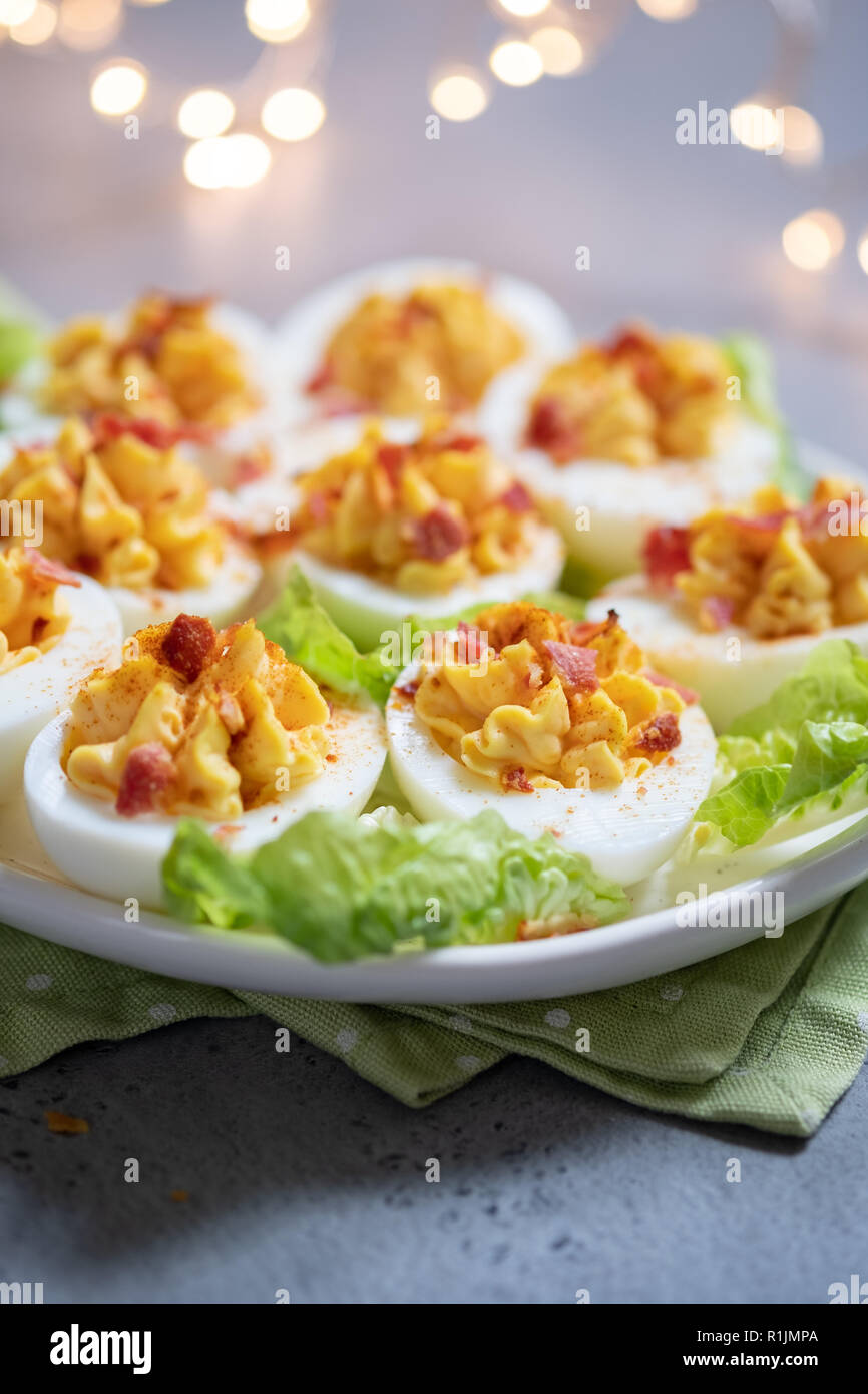 Healthy Deviled Eggs as an Appetizer with Bacon Stock Photo