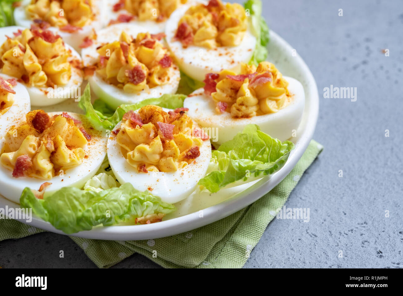 Healthy Deviled Eggs as an Appetizer with Bacon Stock Photo