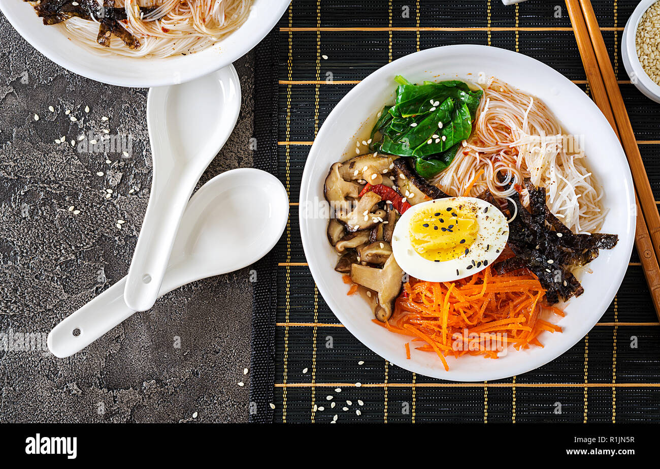 Diet vegetarian bowl of noodle soup of shiitake mushrooms, carrot and