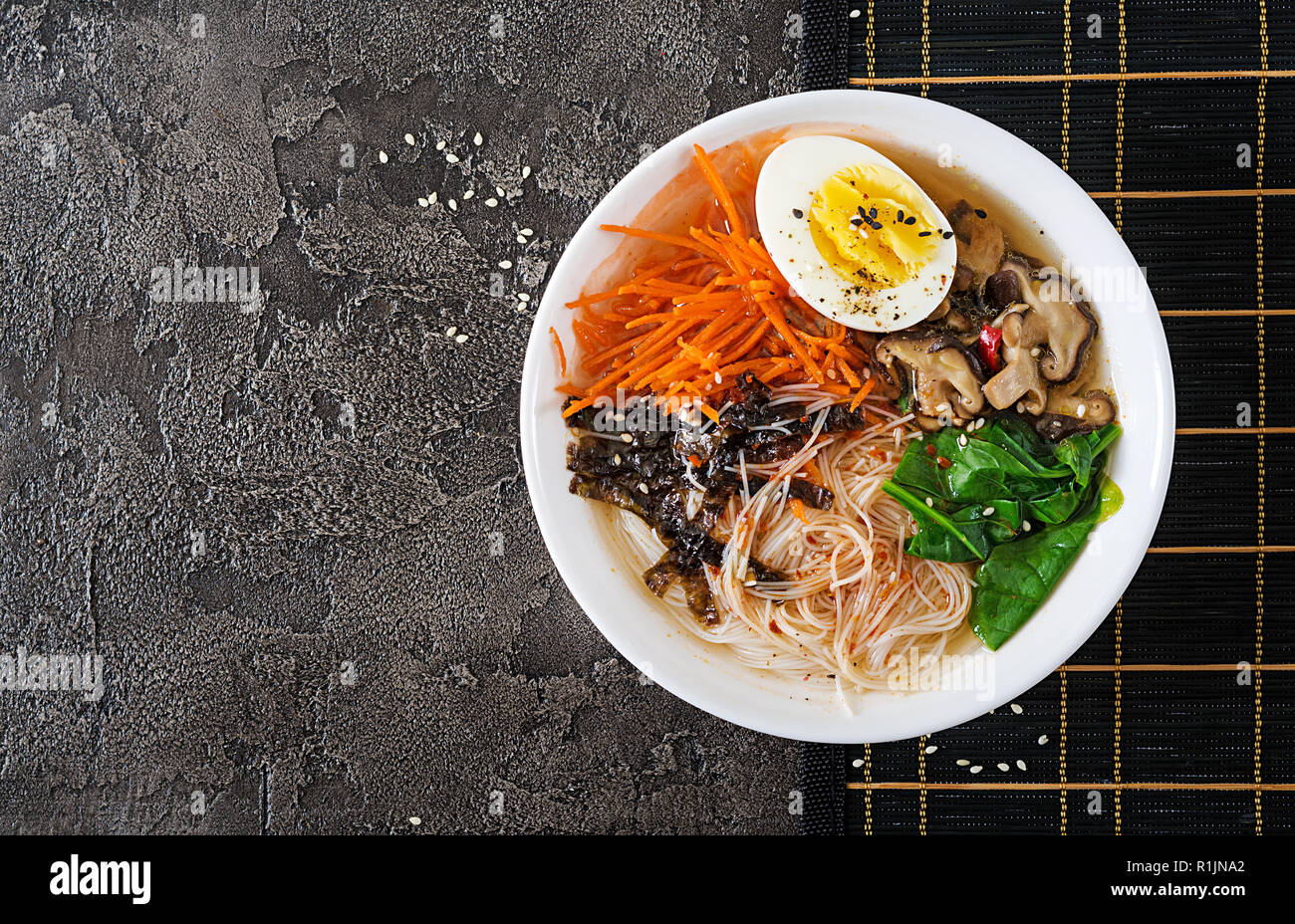 Diet vegetarian bowl of noodle soup of shiitake mushrooms, carrot and