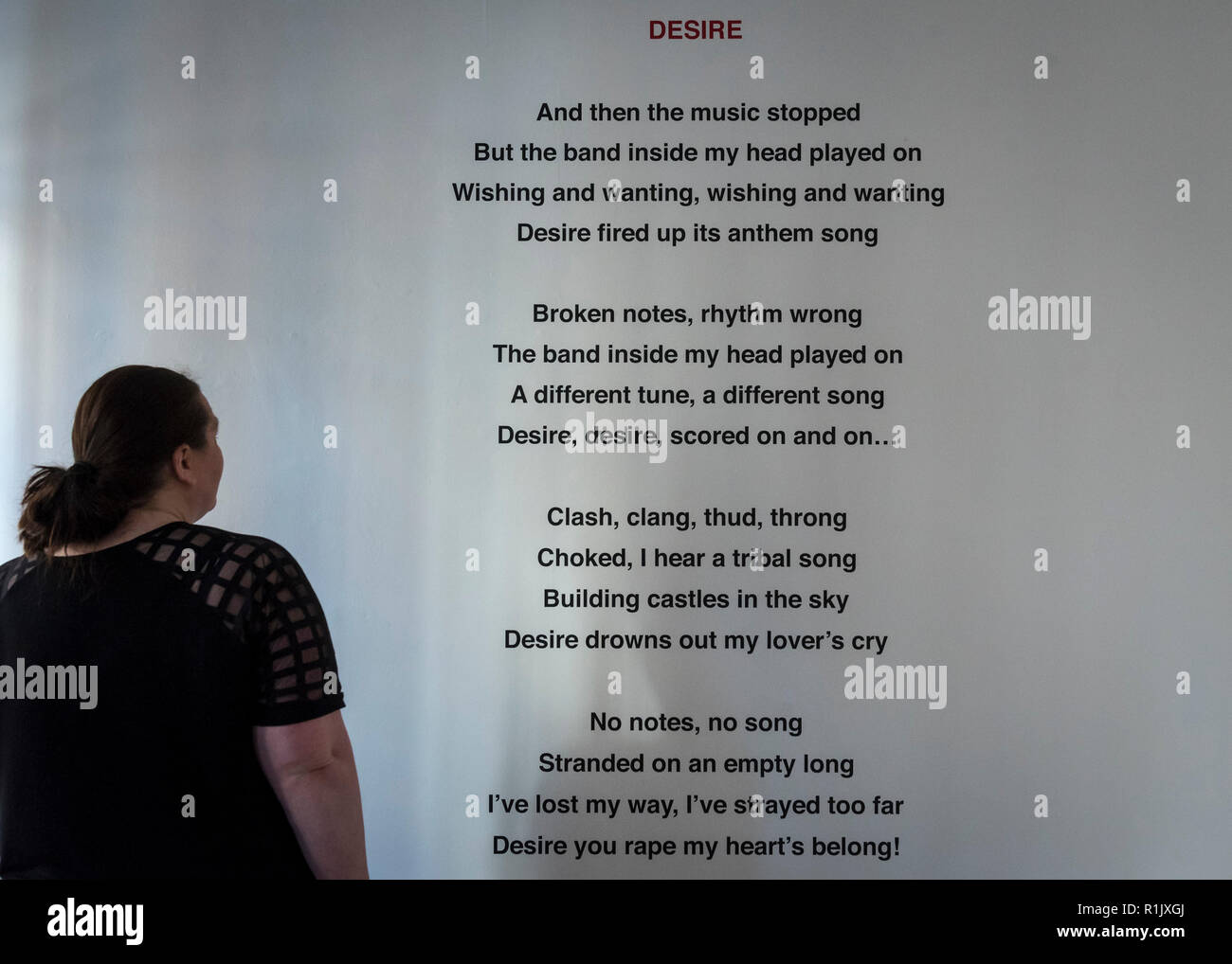 London, UK.  13 November 2018. A staff member views poetry by Christina Reihill.  Preview of 'Glad I Did It', a new work by Irish artist Christina Reihill at Bermondsey Project Space.  The interactive artwork looks at the life and death of Ruth Ellis, the last woman to be hanged in Britain, after she shot her lover, racing driver, David Blakely in 1955.  On display are the artist's interpretation of Ruth Ellis' prison cell, including furniture and props, the hanging room together with a video display of the artist in conversation. Credit: Stephen Chung/Alamy Live News Stock Photo