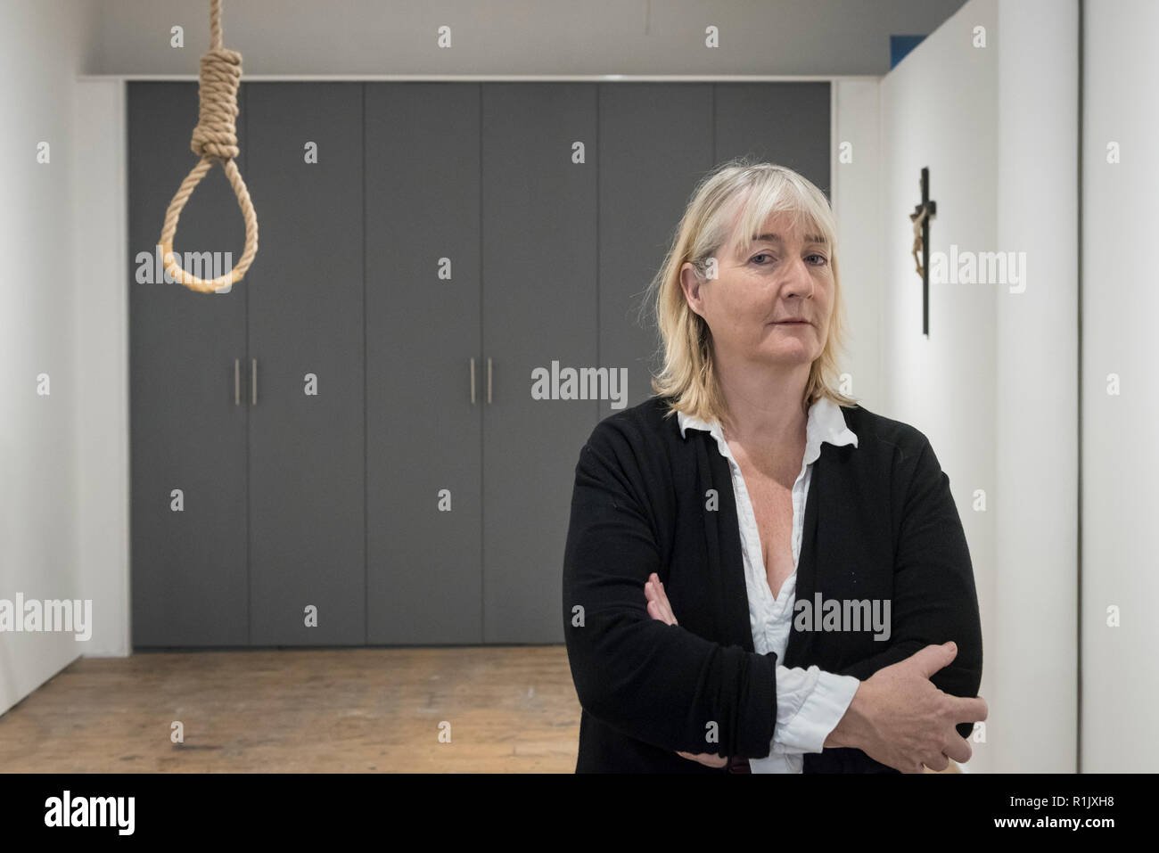 London, UK.  13 November 2018. Artist Christina Reihill poses with a hangman's noose.  Preview of "Glad I Did It", a new work by Irish artist Christina Reihill at Bermondsey Project Space.  The interactive artwork looks at the life and death of Ruth Ellis, the last woman to be hanged in Britain, after she shot her lover, racing driver, David Blakely in 1955.  On display are the artist's interpretation of Ruth Ellis' prison cell, including furniture and props, the hanging room together with a video display of the artist in conversation. Credit: Stephen Chung/Alamy Live News Stock Photo