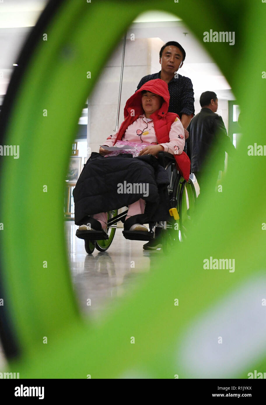 Lanzhou, China's Gansu Province. 13th Nov, 2018. A patient uses a shared wheelchair at the Gansu Provincial Maternity and Child-care Hospital in Lanzhou, capital of northwest China's Gansu Province, on Nov. 13, 2018. Recently, a batch of shared wheelchairs were put into use at the hospital. Users can access the service after scanning the QR code and paying a deposit. The service is free for the first two hours. Credit: Chen Bin/Xinhua/Alamy Live News Stock Photo