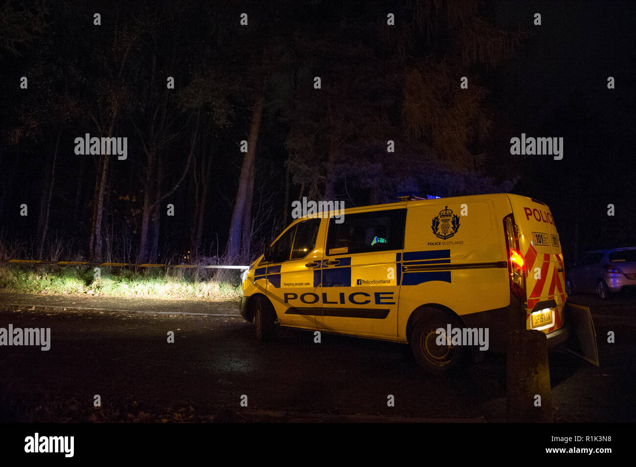 Cumbernauld, UK. 13th Nov, 2018. Police Incident of a suspected attack in the Seafar area of Cumbernauld at 8pm. Police have cordoned off the area with tape and are investigating but not giving any details out. One person has been taken away in an ambulance with the blue lights and siren on.  A car remains on the scene along with a heavily wooded area cordoned off for investigation. Around 5 officers, 2 police units and an ambulance were in attendance.  Credit: Colin Fisher/Alamy Live News Stock Photo