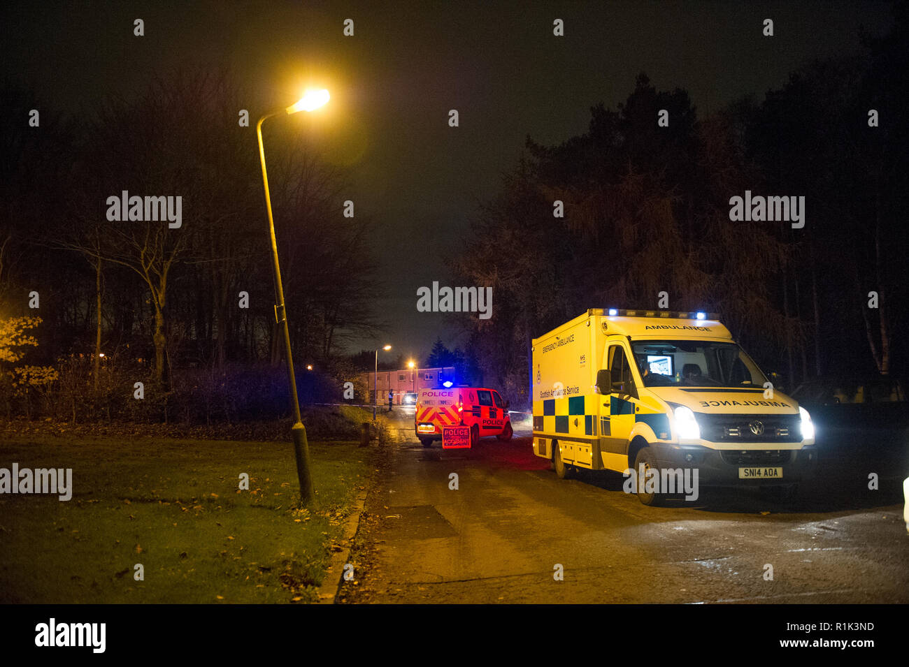 Cumbernauld, UK. 13th Nov, 2018. Police Incident of a suspected attack in the Seafar area of Cumbernauld at 8pm. Police have cordoned off the area with tape and are investigating but not giving any details out. One person has been taken away in an ambulance with the blue lights and siren on.  A car remains on the scene along with a heavily wooded area cordoned off for investigation. Around 5 officers, 2 police units and an ambulance were in attendance.  Credit: Colin Fisher/Alamy Live News Stock Photo