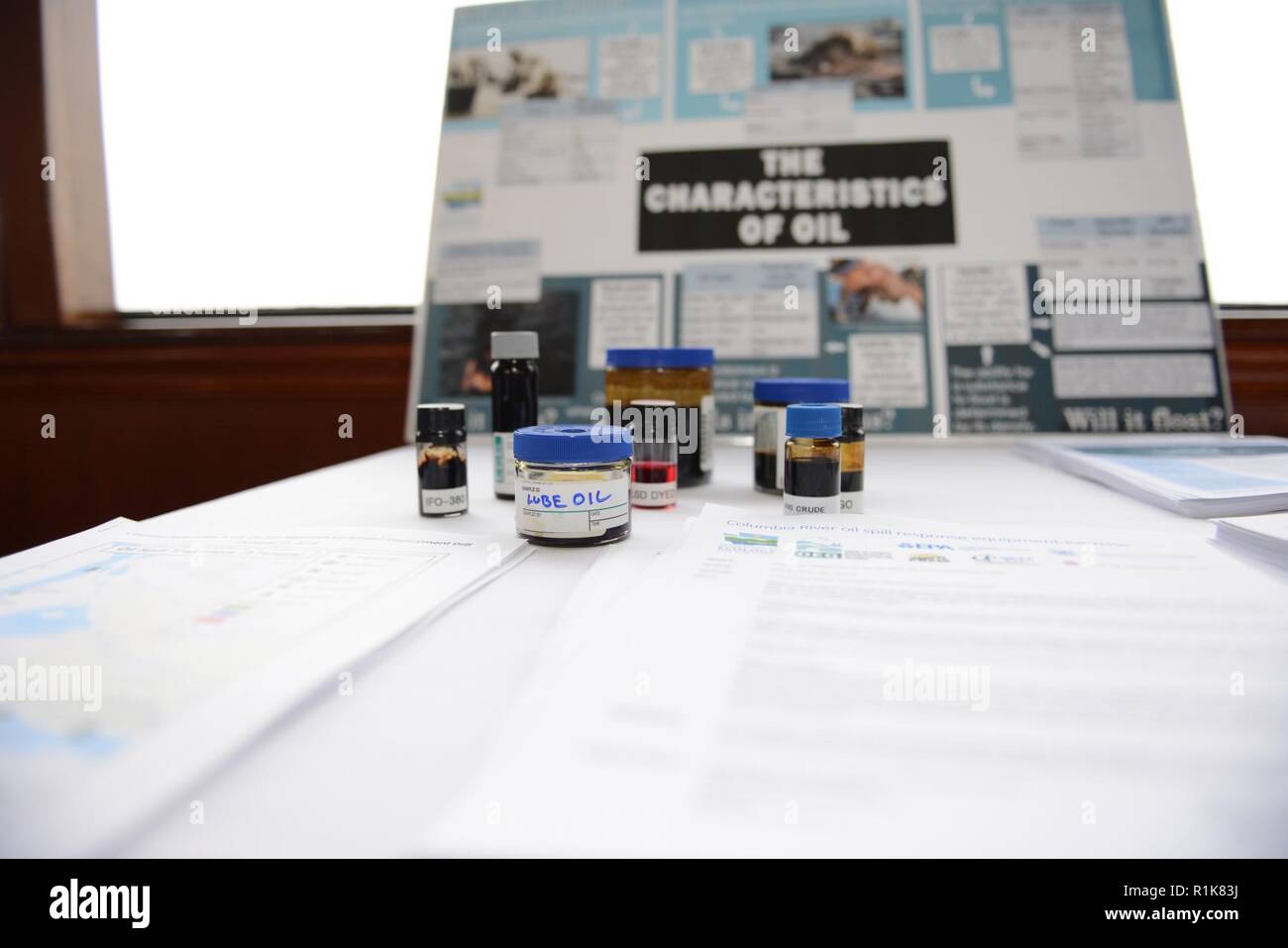 Samples of different types of oil product are displayed on a tabletop during an organized oil spill response equipment exercise on the Columbia River near Vancouver, Wash., Oct. 10, 2018.    Nine oil companies and their response contractors practiced responding to an oil spill on the Columbia River using floating containment boom and oil skimming vessels. Stock Photo