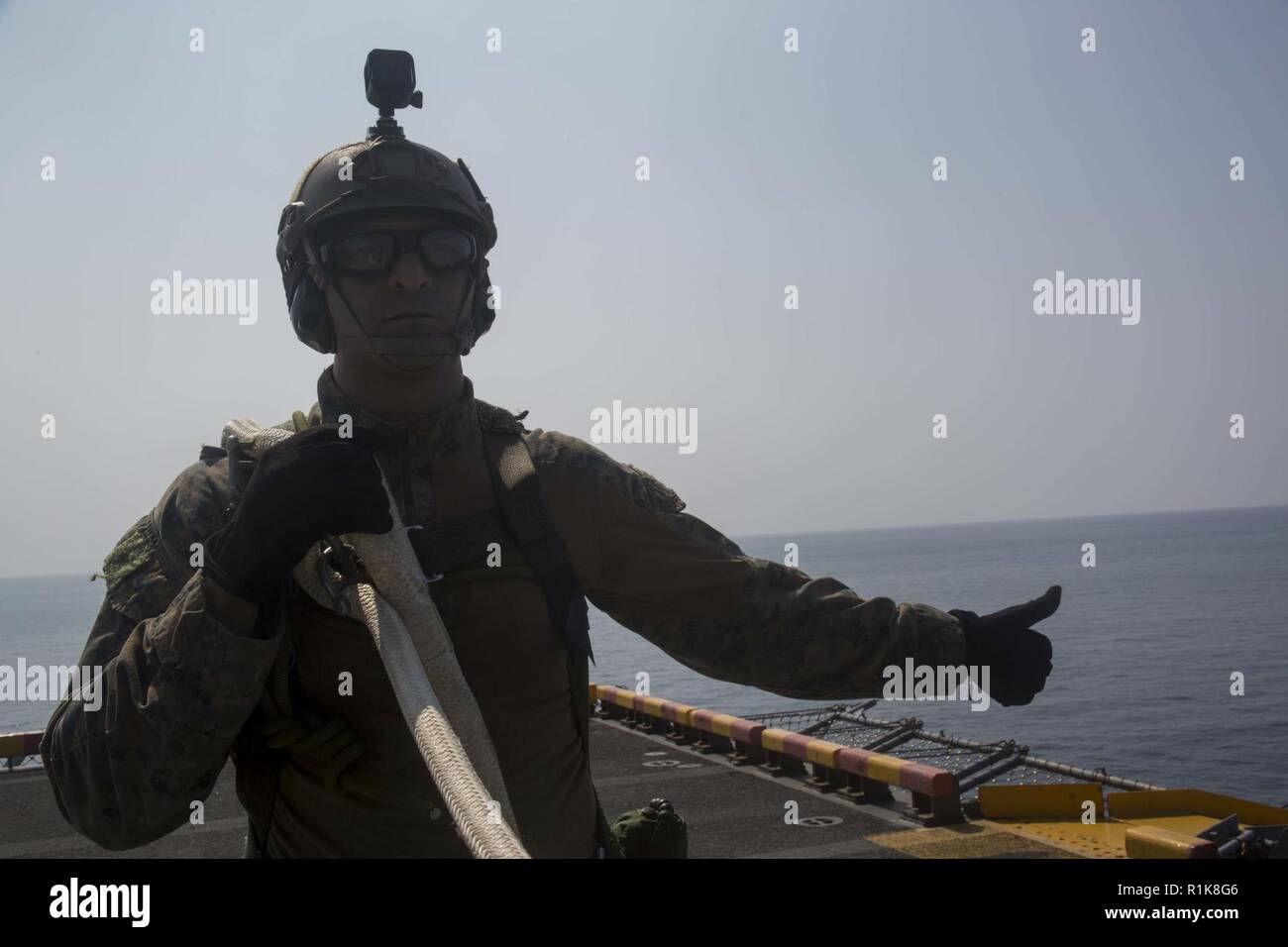 Gunnery Sgt. Jesus Cisneros Jr., the platoon sergeant for the 31st Marine Expeditionary Unit’s Amphibious Reconnaissance Platoon, attaches to a line during Special Patrol Insertion and Extraction training aboard the amphibious assault ship USS Wasp (LHD 1), underway in the South China Sea, Oct. 11, 2018. Cisneros, a native of Lake Station, Indiana, graduated River Forest High School in May 1997 and enlisted in January 2004. SPIE rigging allows Marines to enter and exit tactical landing zones that are inaccessible to helicopters during amphibious operations. The Seahawk belongs to Helicopter Se Stock Photo