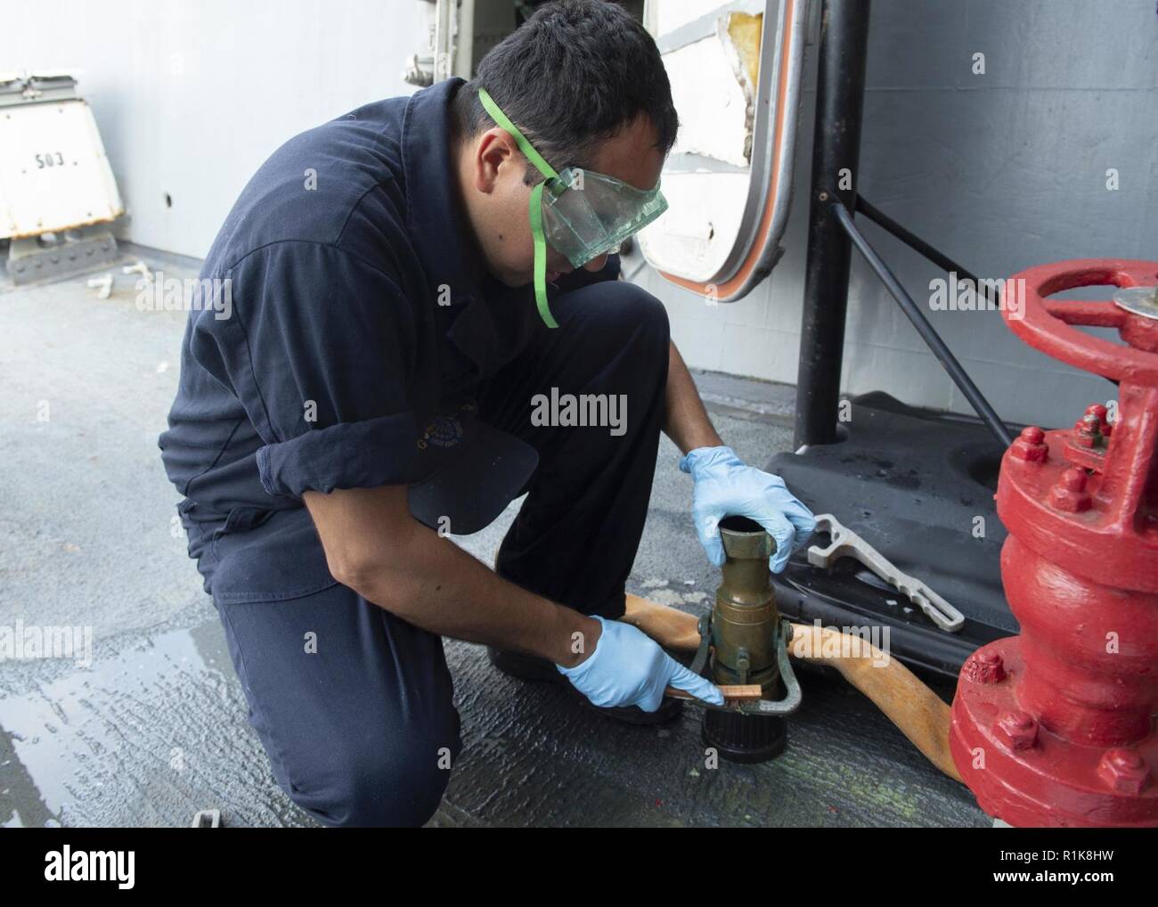 MEDITERRANEAN SEA (Oct. 8, 2018) Seaman Antonio Maldonadovega cleans a vari-nozzle aboard the Arleigh Burke-class guided-missile destroyer USS Arleigh Burke (DDG 51) in the Mediterranean Sea Oct. 8, 2018. Arleigh Burke, homeported at Naval Station Norfolk, is conducting naval operations in the U.S. 6th Fleet area of operations in support of U.S. national security interests in Europe and Africa. Stock Photo