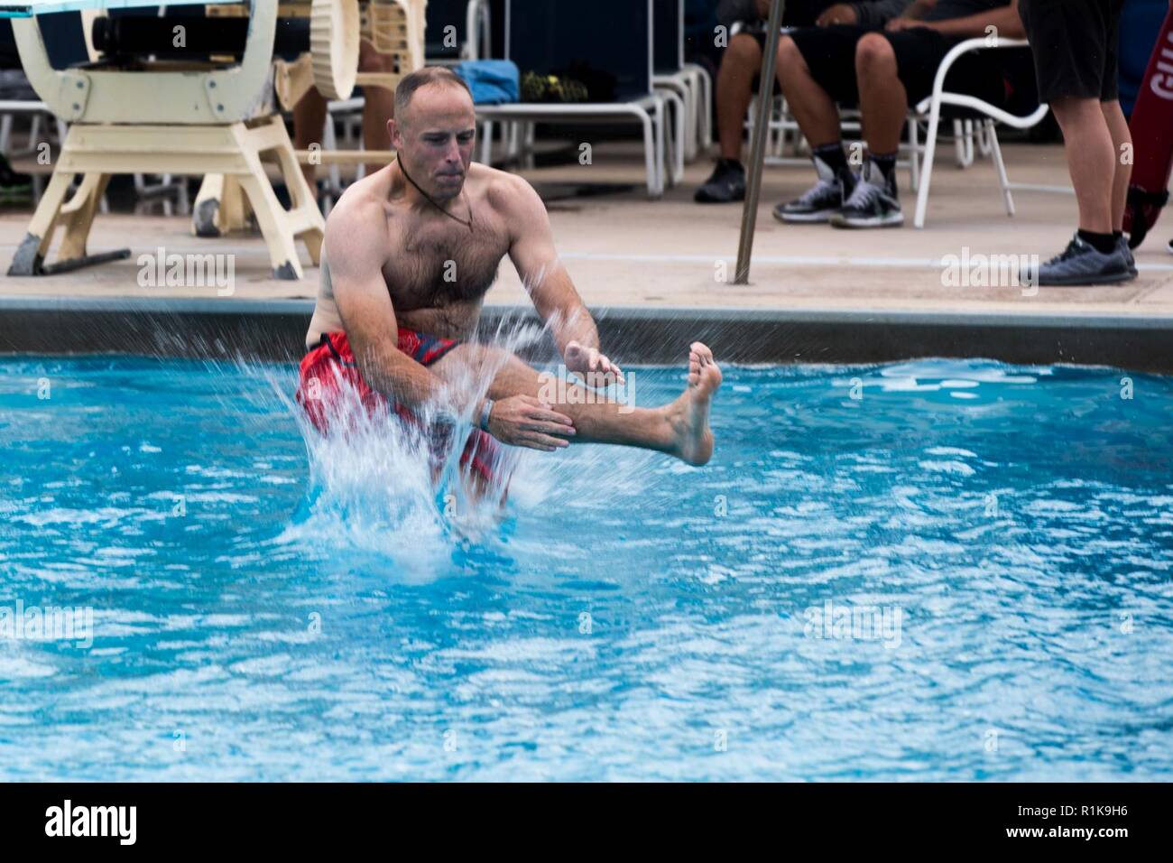 U.S. Marine Corps Gunnery Sgt. Cory Canterbury, operations chief, Marine Corps Tactical Systems Support Activity, Marine Corps Systems Command, jumps into the water during the Commanding General’s (CG’s) Cup Dive Competition at the 13 Area Pool, Marine Corps Base Camp Pendleton, California, Oct. 11, 2018. The CG’s Cup is an intramural sports program that was developed to give service members from various units across MCB Camp Pendleton an opportunity to compete in organized sporting events in order to promote fitness, teamwork and esprit de corps. The CG’s cup also allows service members to ea Stock Photo