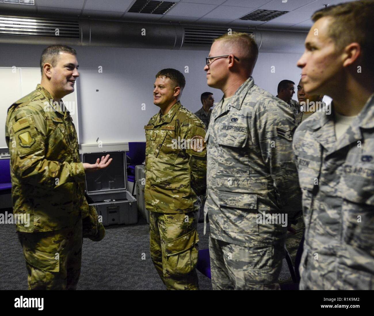 U.S. Air Force Brig. Gen. Mark R. August, 86th Airlift Wing commander, speaks with Airmen of the 86th Aircraft Maintenance Squadron during an immersion tour of the 86th Maintenance Group on Ramstein Air Base, Germany, Oct. 9, 2018. August and Chief Master Sgt. Ernesto J. Rendon Jr., 86th AW command chief, used the immersion as a way to get a better understanding of the 86th MXG’s capabilities as well as a way for Airmen to ask questions directly to the wing leaders. Stock Photo