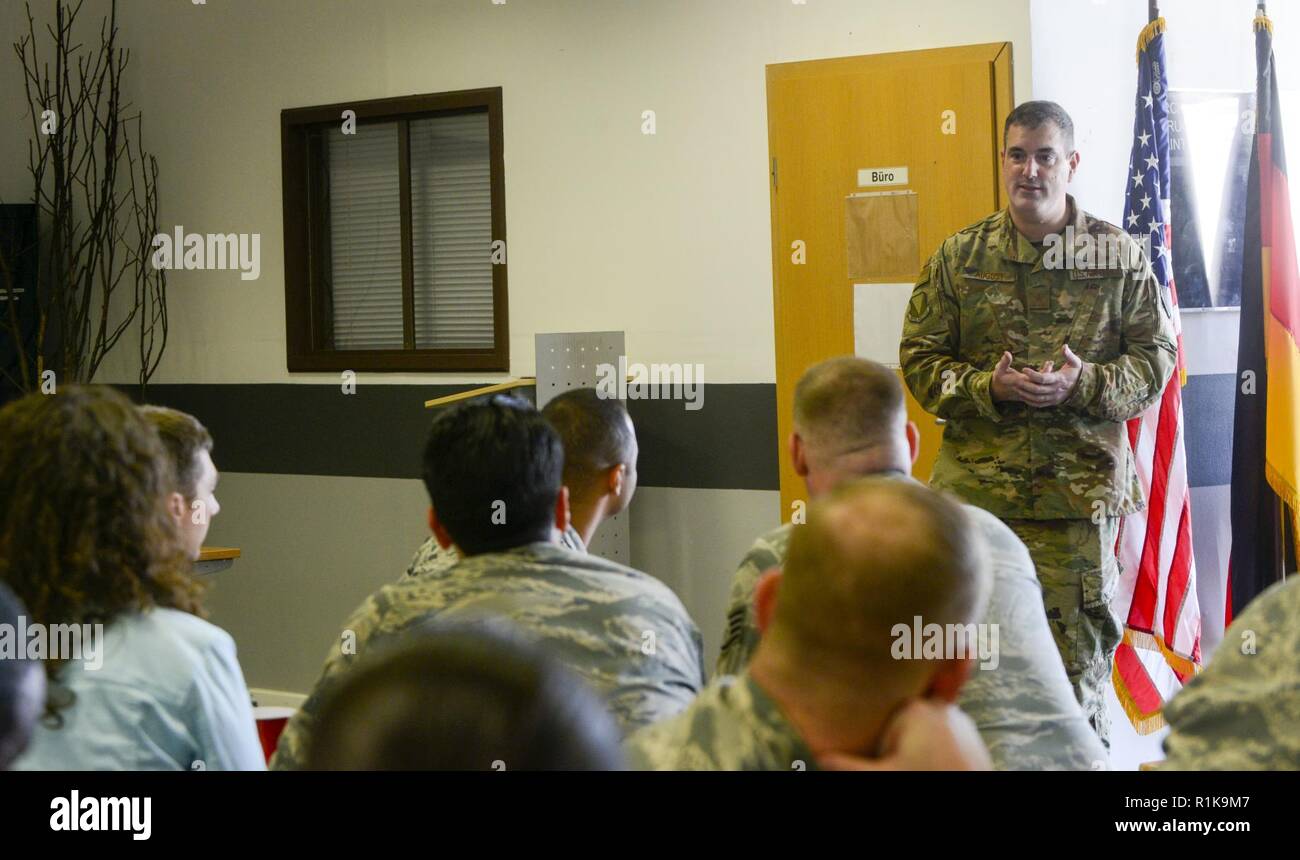 U.S. Air Force Brig. Gen. Mark R. August, 86th Airlift Wing commander, answers questions during an immersion tour of the 86th Maintenance Group on Ramstein Air Base, Germany, Oct. 9, 2018. August and Chief Master Sgt. Ernesto J. Rendon Jr., 86th AW command chief, used the immersion as a way to get a better understanding of the 86th MXG’s capabilities as well as a way for Airmen to ask questions directly to the wing leaders. Stock Photo