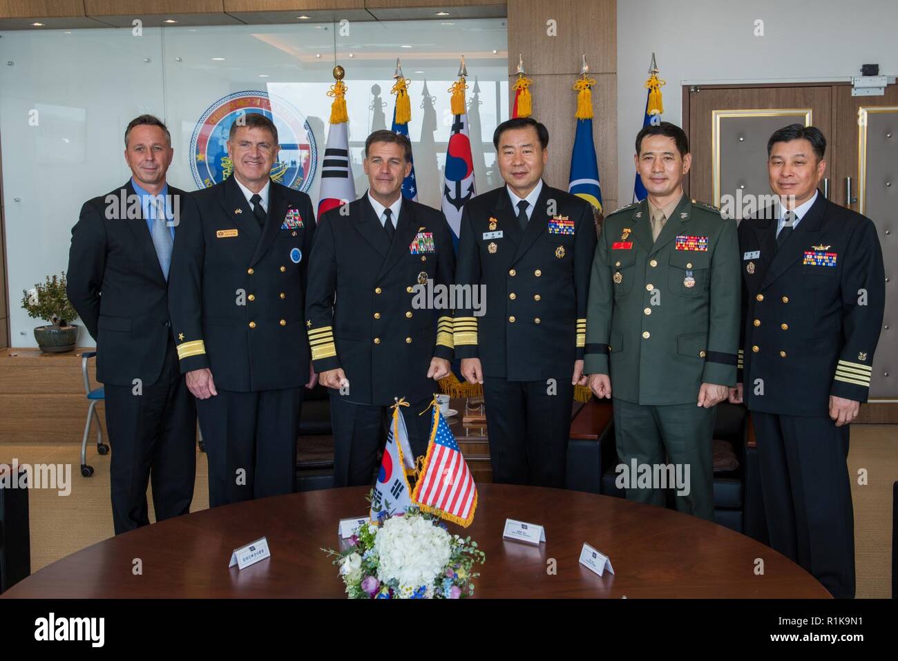 JEJU ISLAND, Republic of Korea, Republic of Korea (Oct. 11, 2018) Adm. John Aquilino (left center), commander, U.S. Pacific Fleet, poses for a group photo with Republic of Korea (ROK) Chief of Naval Operations (CNO) Adm. Sim, Seung-seob (right center) during an office call in Jeju. Aquilino is visiting the ROK to observe the 2018 ROK International Fleet review as well as attend the 2018 Western Pacific Naval Symposium being hosted by the ROK Navy. Stock Photo
