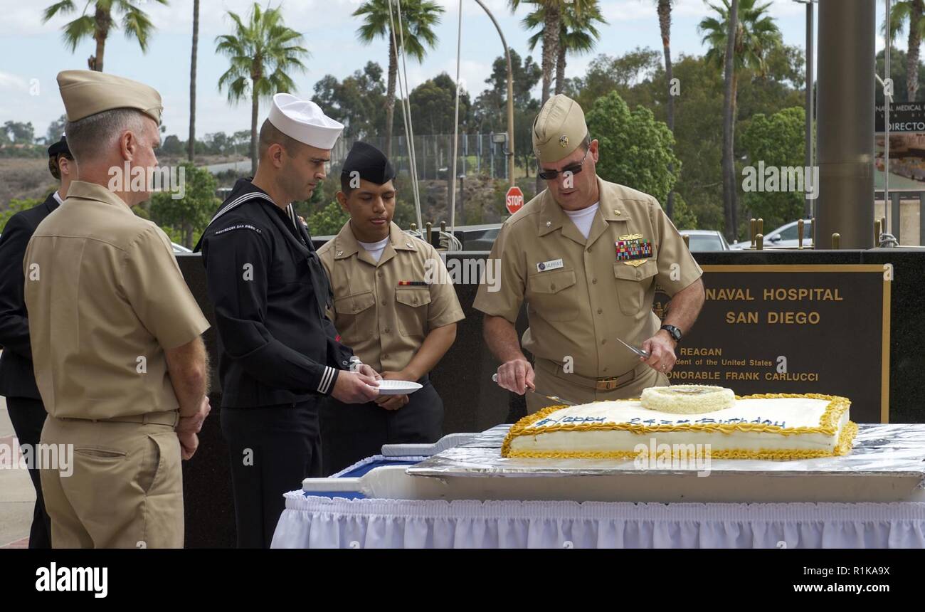 SAN DIEIGO (Oct. 12,2018) — Cmdr Michael Merry, the oldest Sailor present, cuts the first piece of cake for Capt. Bradford Smith, Naval Medical Center San Diego (NMCSD) commanding officer during the Navy’s 243rd Birthday Celebration held in the courtyard. NMCSD is the largest naval hospital on the west coast, employing more than 6,000 Sailors, civilians and contractors. Stock Photo