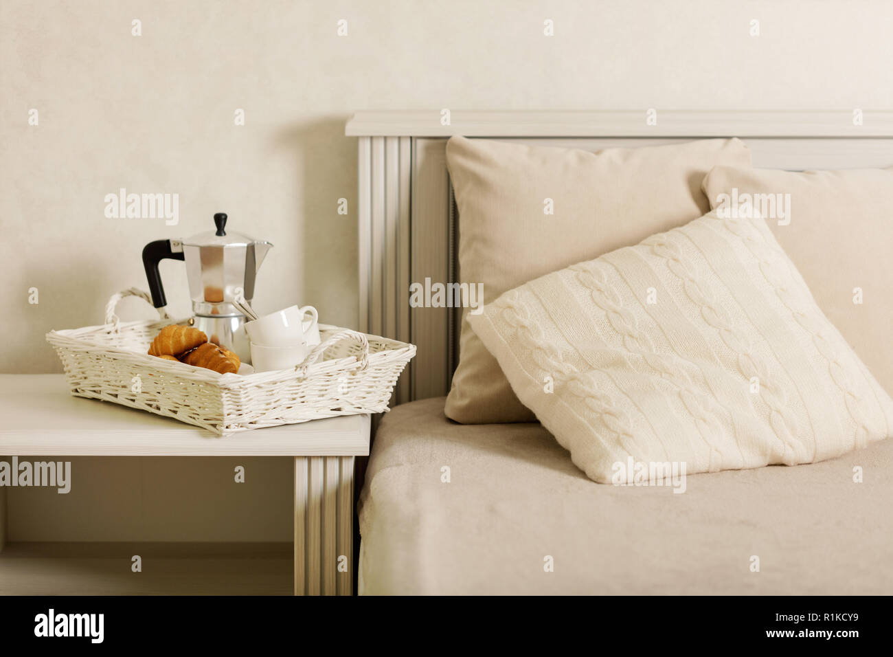 bed. On a white wicker tray there 
