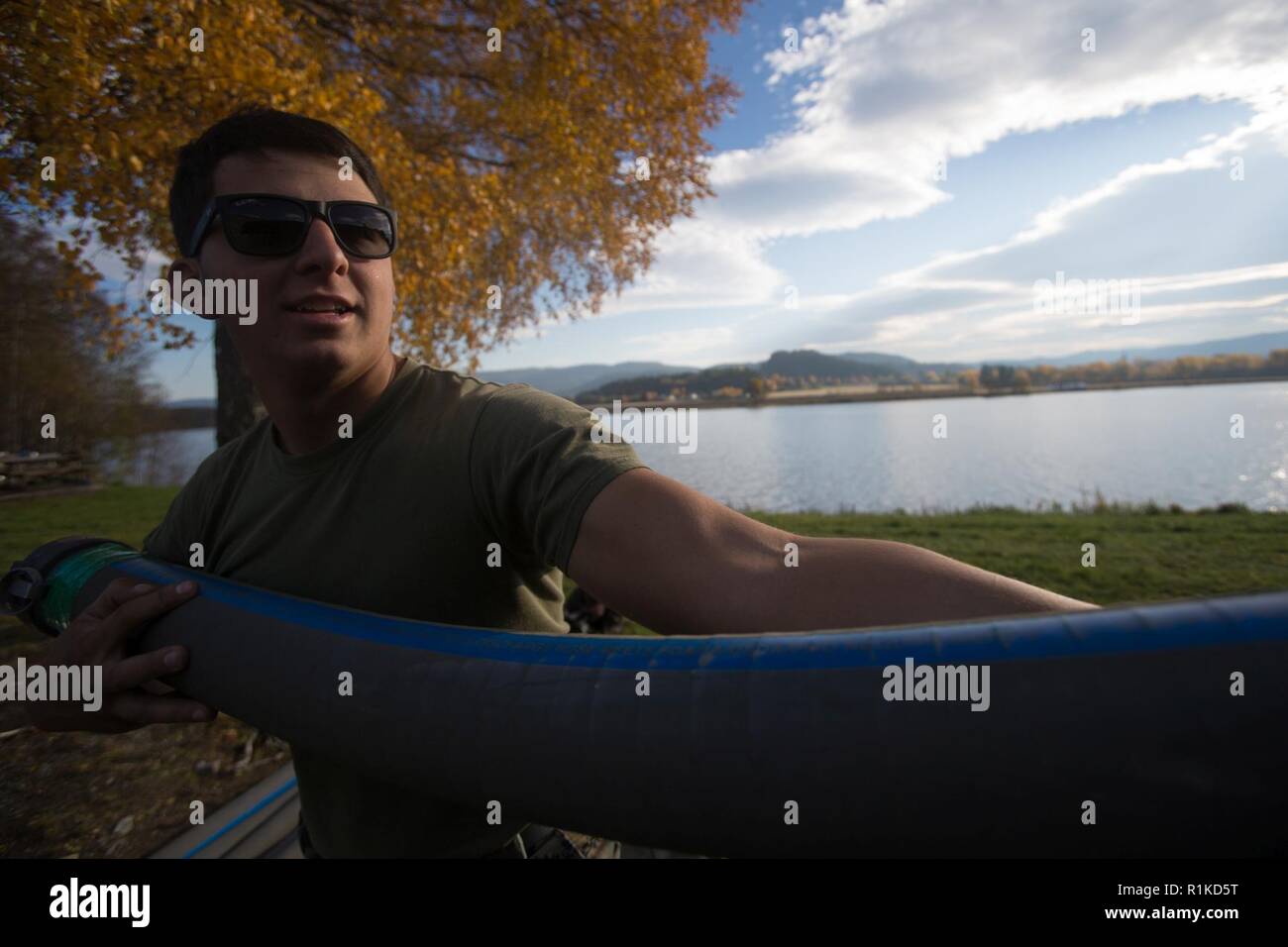 U.S. Marine Corps Lance Cpl. Israel Santibanez with 8th Engineer Battalion, 2nd Marine Logistics Group-Forward, pulls an ocean intake hose out of a tactical water purification system inVærnes, Norway, Oct. 12, 2018. Marines purified water and made potable for use in camp support and operations during Exercise Trident Juncture 18. Trident Juncture enhances the U.S. and NATO Allies’ and partners’ abilities to work together collectively to conduct military operations under challenging conditions. Stock Photo