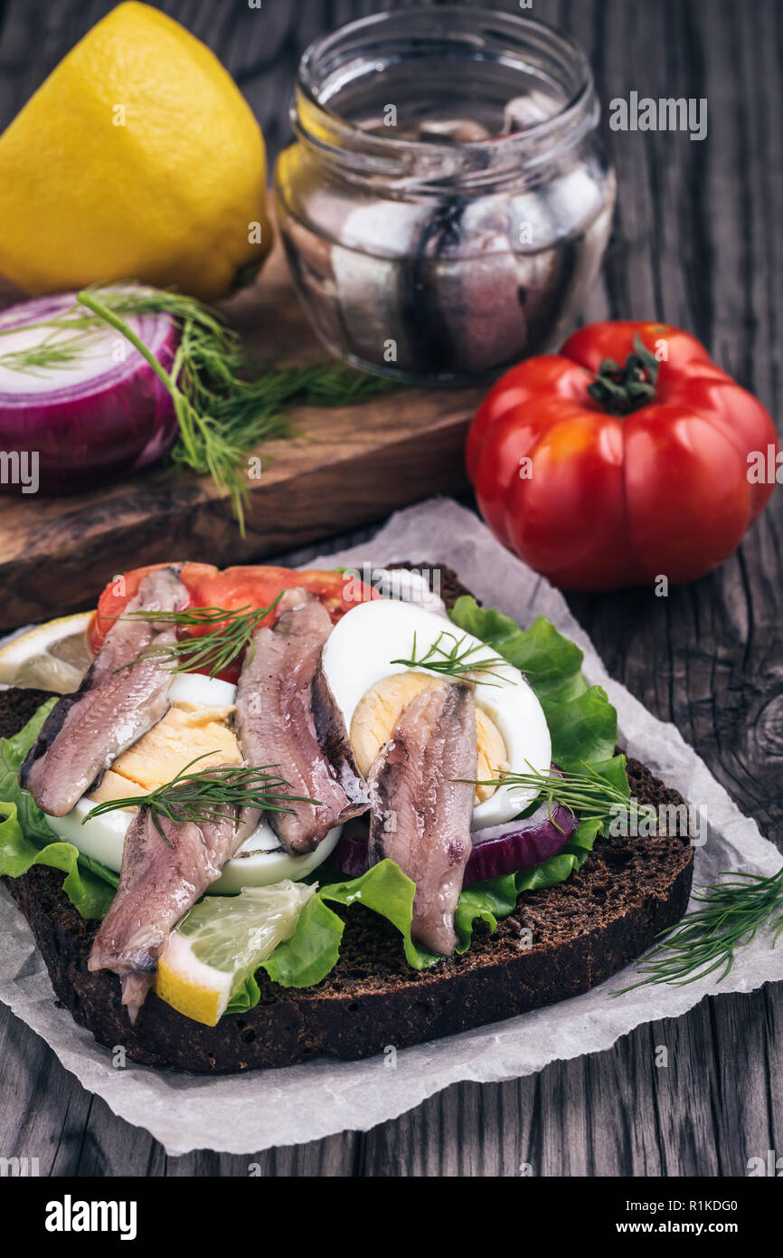 Sandwich with anchovy on table Stock Photo