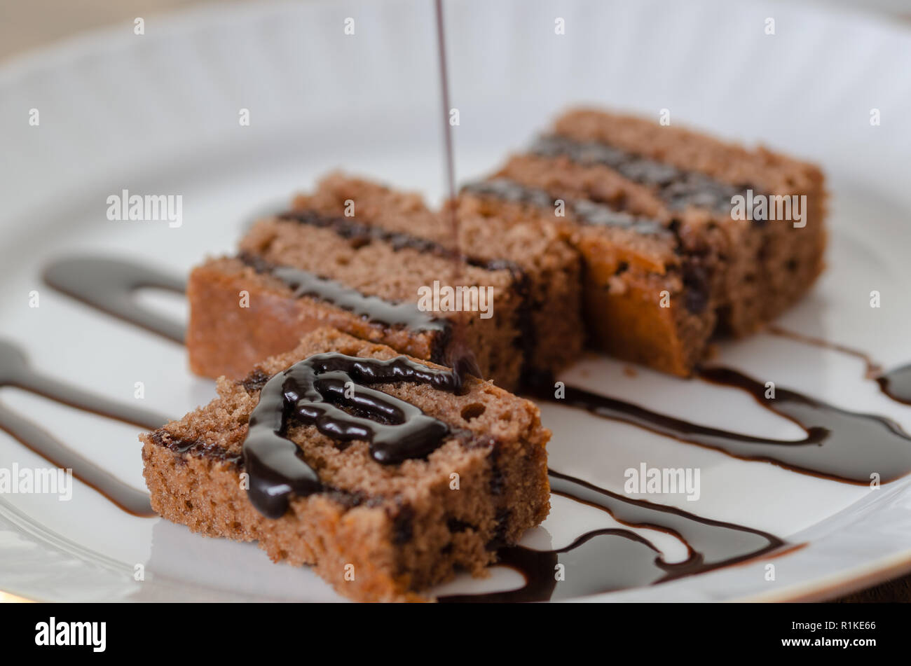 Chocolate cake with chocolate cream isolated on white dish. Stock Photo