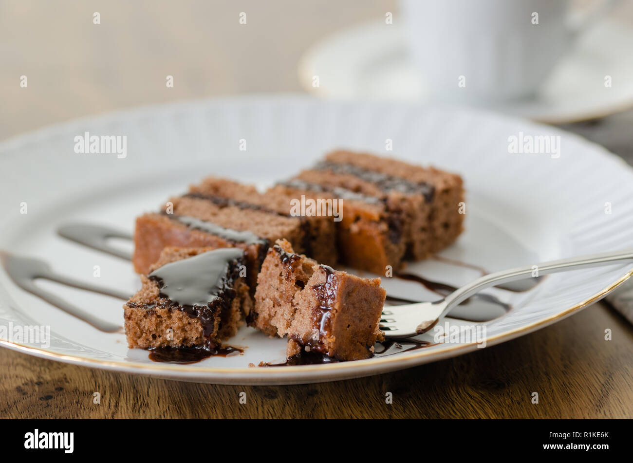 Chocolate cake with chocolate cream isolated on white dish. Stock Photo