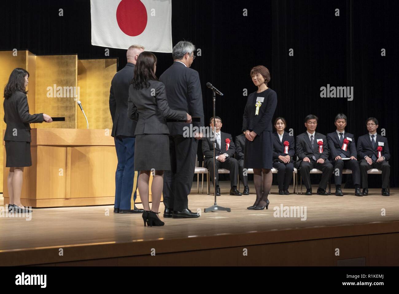 Rie Miyoshi, Stars and Stripes Tokyo management analyst, prepares to  receive her award for her years of service during the USFJ  Length-of-Service Awards Ceremony at the Yutorogi Hall in Hamura City,  Japan,