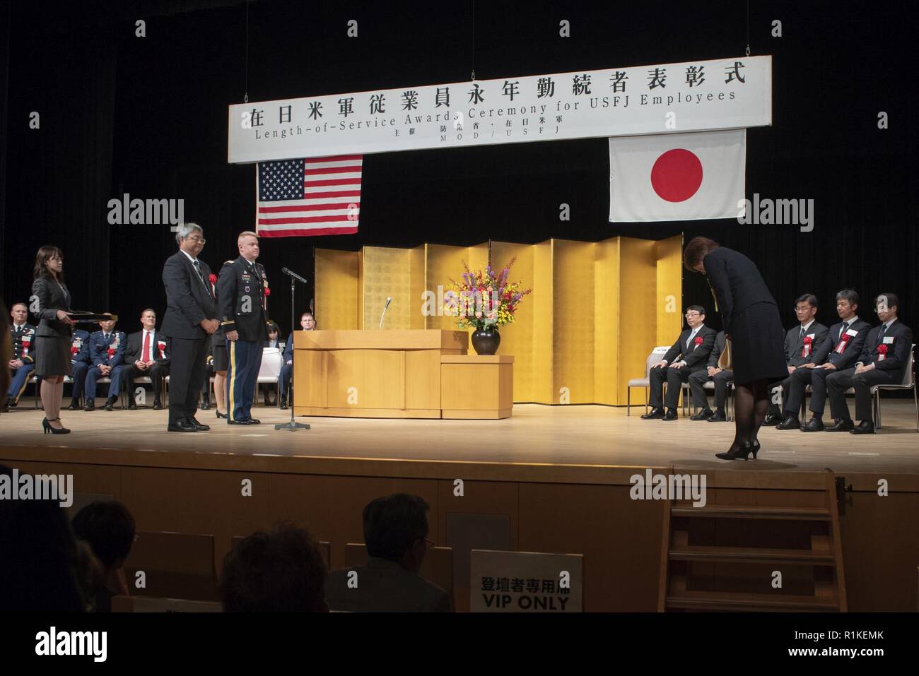 Rie Miyoshi, Stars and Stripes Tokyo management analyst, bows as a sign of  respect after receiving an award for her years of service at the USFJ  Length-of-Service Awards Ceremony at the Yutorogi