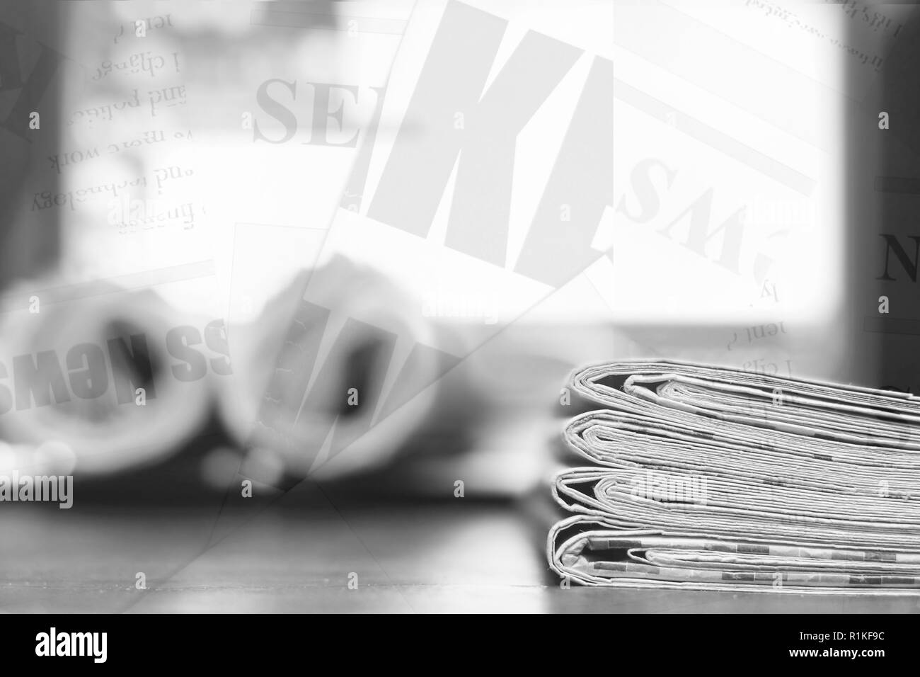 Newspaper background. Pile of papers with news and blurred screen of laptop, partially shown words, headlines and articles as overlay texture Stock Photo