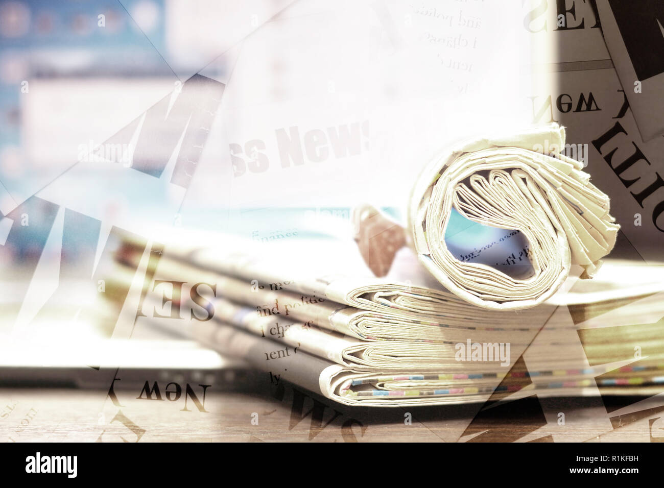 Newspaper background. Pile of papers with news and blurred screen of laptop, partially shown words, headlines and articles as overlay texture Stock Photo