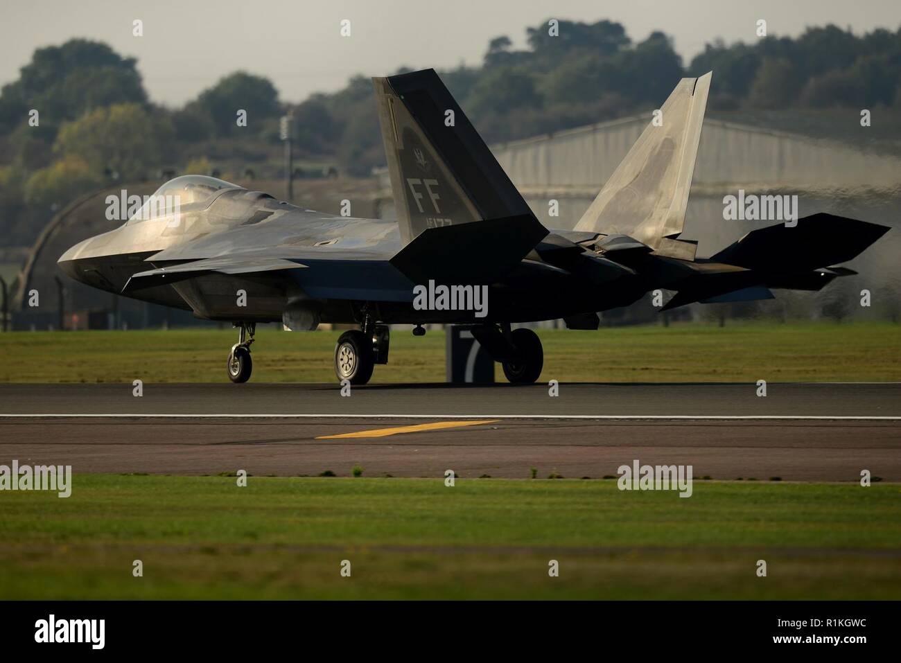 An F-22 Raptor assigned to the 1st Fighter Wing, Joint Base Langley-Eustis, Va. returns from a training sortie at Royal Air Force Lakenheath, England, Oct. 16, 2018. The Raptors are training with U.S. allies and partners as a demonstration of U.S. commitment to European regional security. Stock Photo