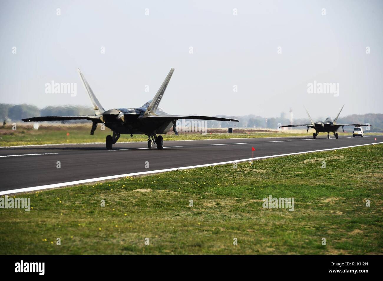 F-22 Raptors from the 1st Fighter Wing out of Joint Base Langley-Eustis, Va., arrive at Kleine-Brogel Air Base, Belgium, Oct. 17, 2018. The aircraft are part of Raptor Redeploy 19-1, conducting short-term visits across Europe. Stock Photo