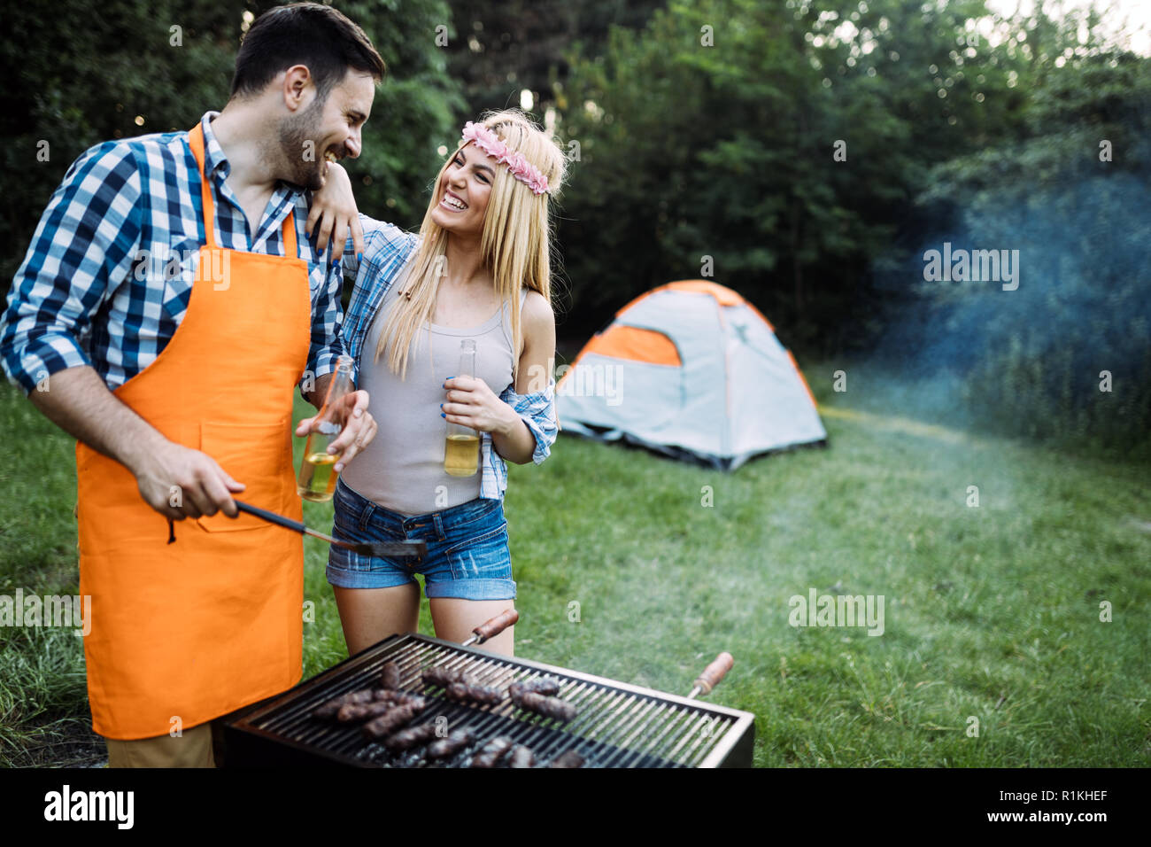 Beautiful woman and handsome man having barbecue Stock Photo