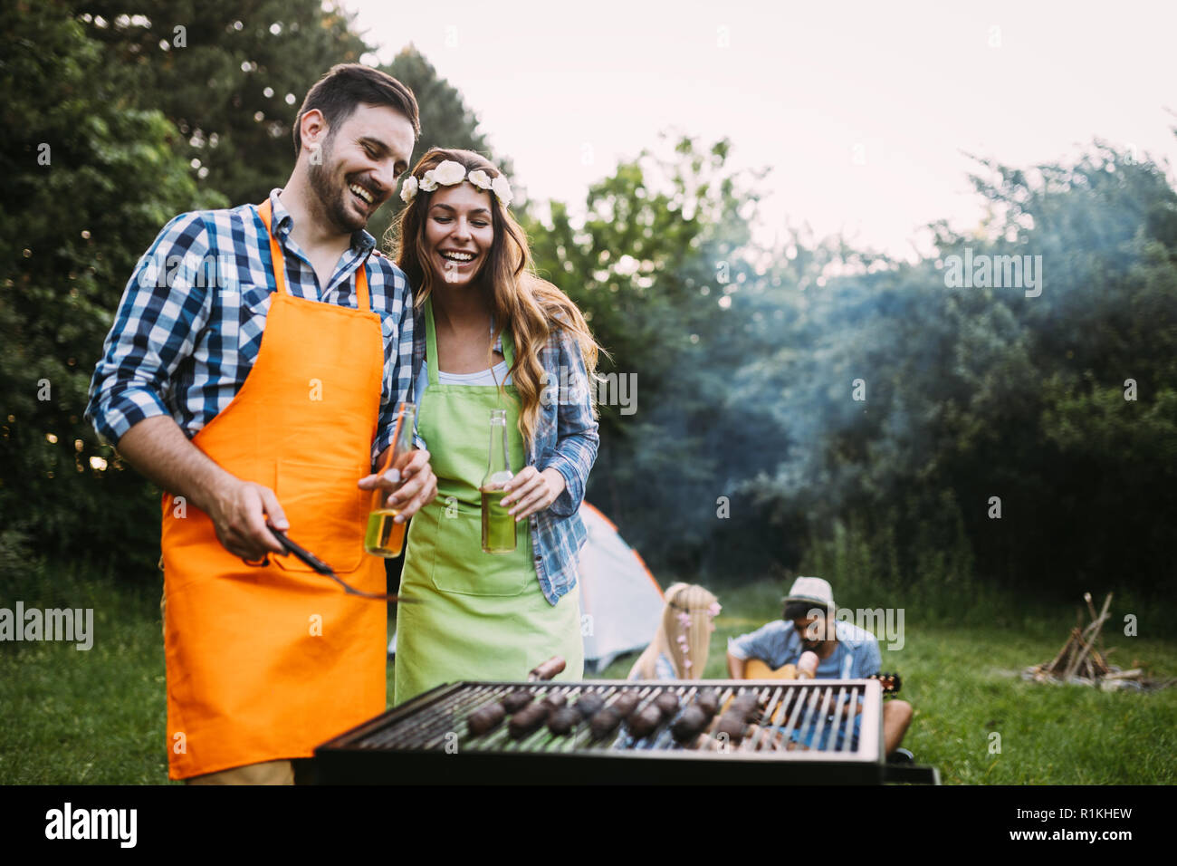 Beautiful woman and handsome man having barbecue Stock Photo