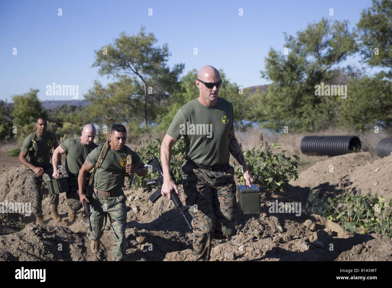 U.S. Marines cross through an obstacle during the Fire Team Challenge as a part of the Commanding General’s (CG’s) Cup at Lake O’Neill, Marine Corps Base Camp Pendleton, California, Oct. 17, 2018. The CG’s Cup is an intramural sports program that was developed to give service members from various units across MCB Camp Pendleton an opportunity to compete in organized sporting events in order to promote fitness, teamwork and esprit de corps. The CG’s cup also allows service members to earn points for their units, resulting in prizes and awards that are presented to the top-earning units at the c Stock Photo