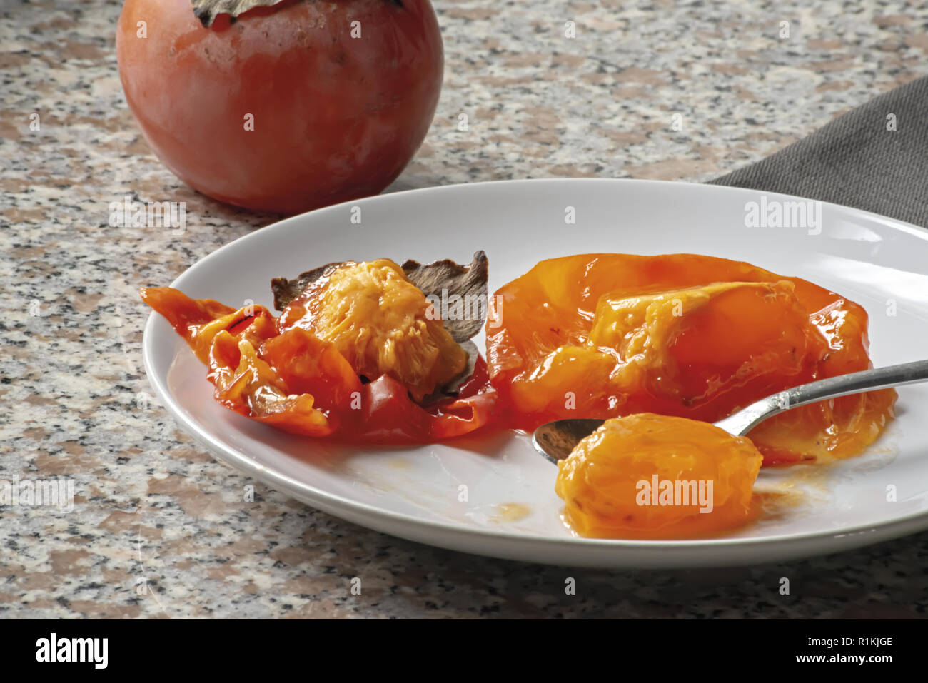kaki fruit in the dish ate almost everything 2 Stock Photo