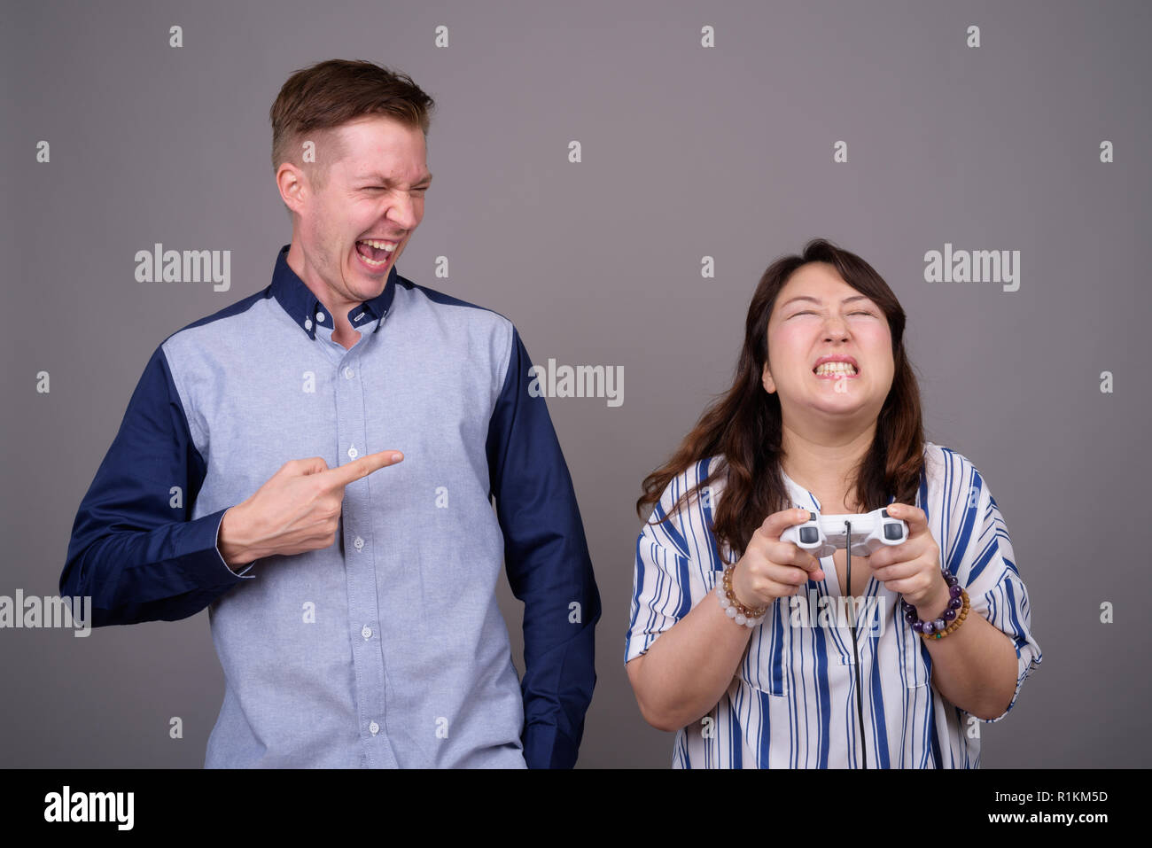 Portrait of multi ethnic diverse couple playing video games Stock Photo